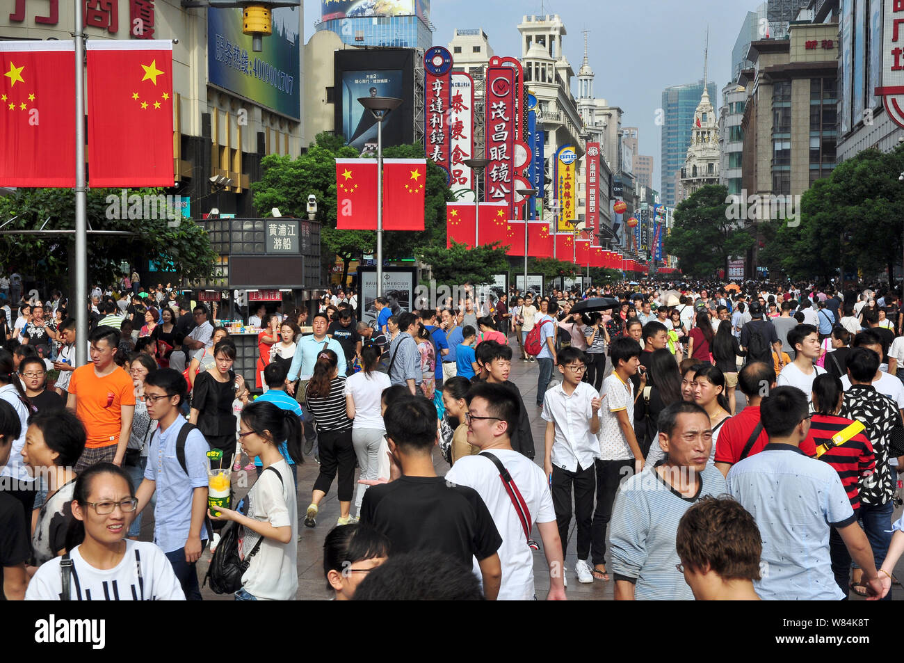 Tourists crowd the Nanjing Road pedestrian shopping street during the National Day holiday in Shanghai, China, 1 October 2016.   Chinese tourists is f Stock Photo