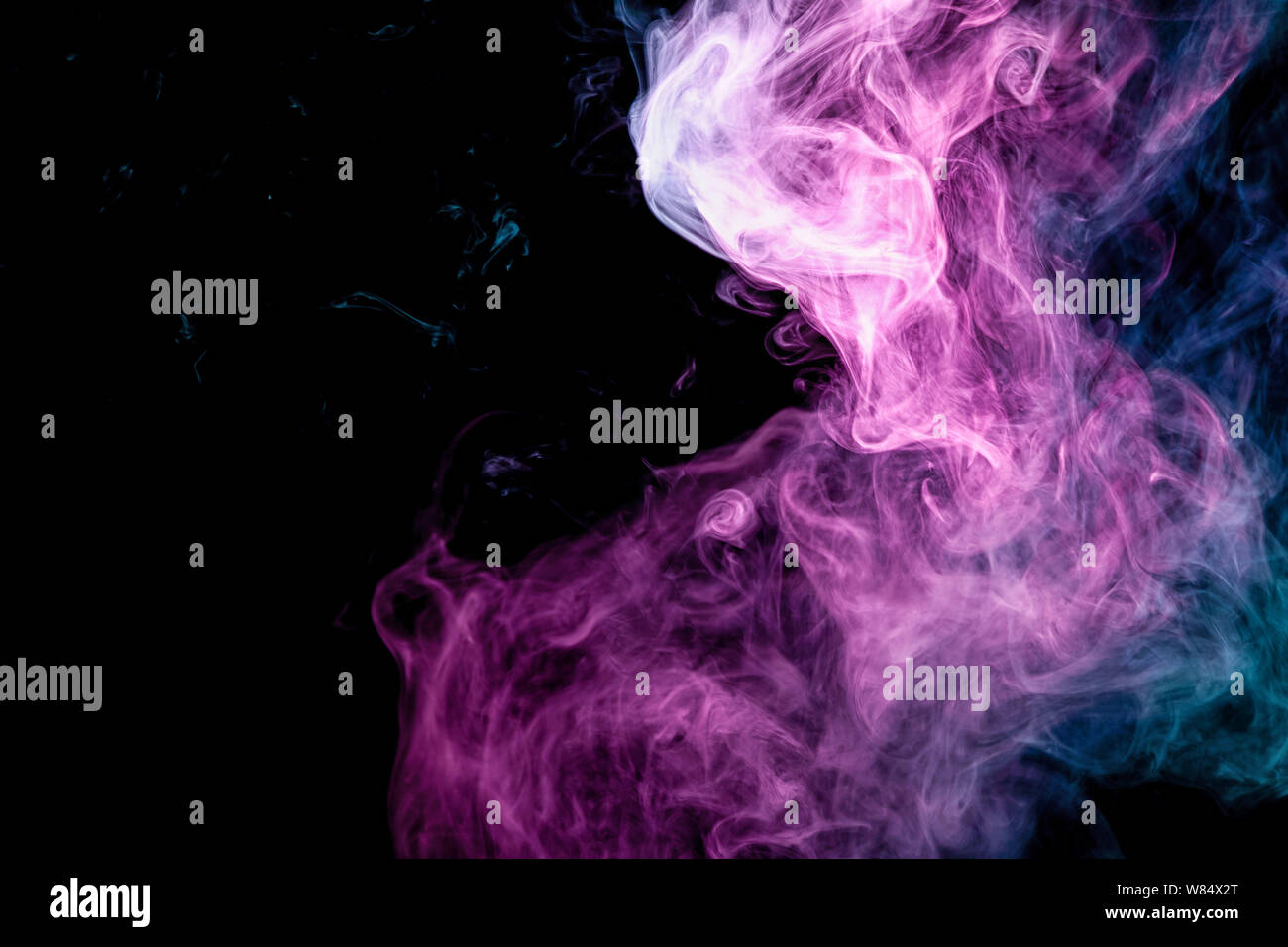 Blue and pink bomb smoke on black isolated background Stock Photo - Alamy