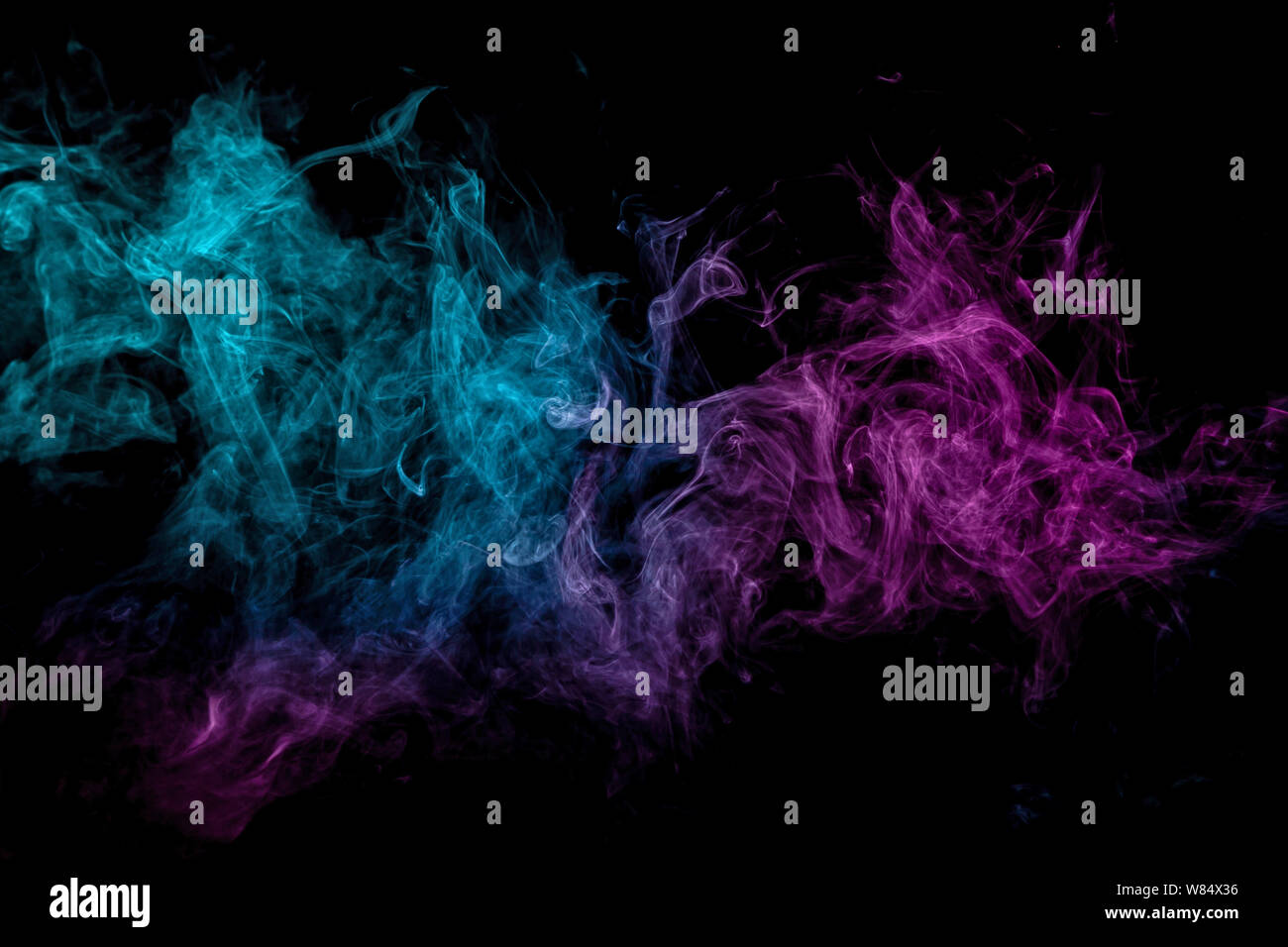 Blue and pink bomb smoke on black isolated background Stock Photo - Alamy