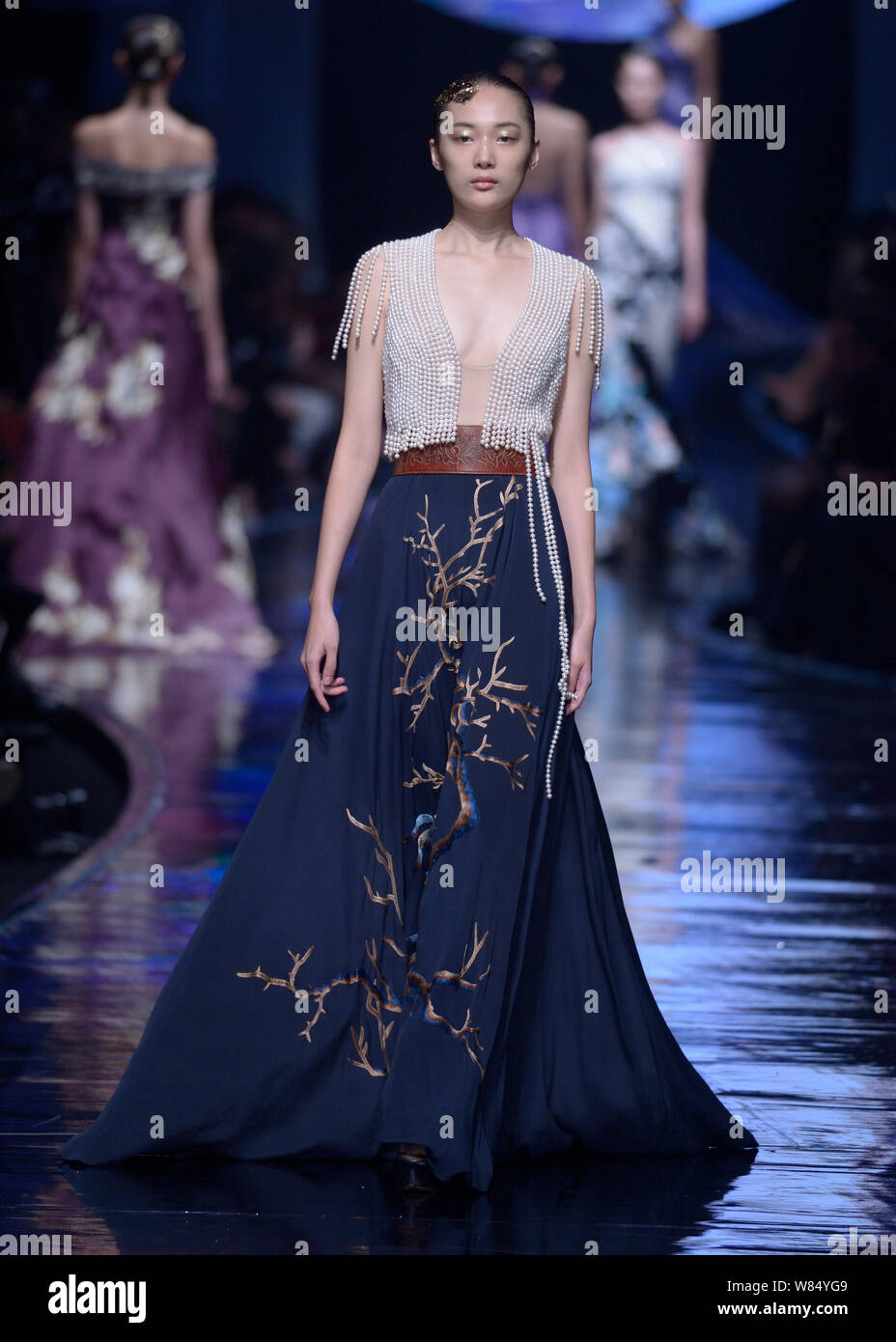 A model displays a new creation by Laurence Xu at a fashion show