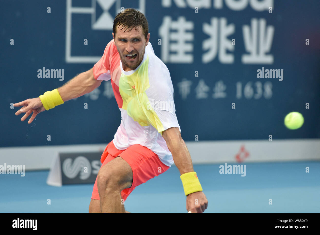Mischa Zverev of Germany returns a shot to Li Zhe of China in their ...