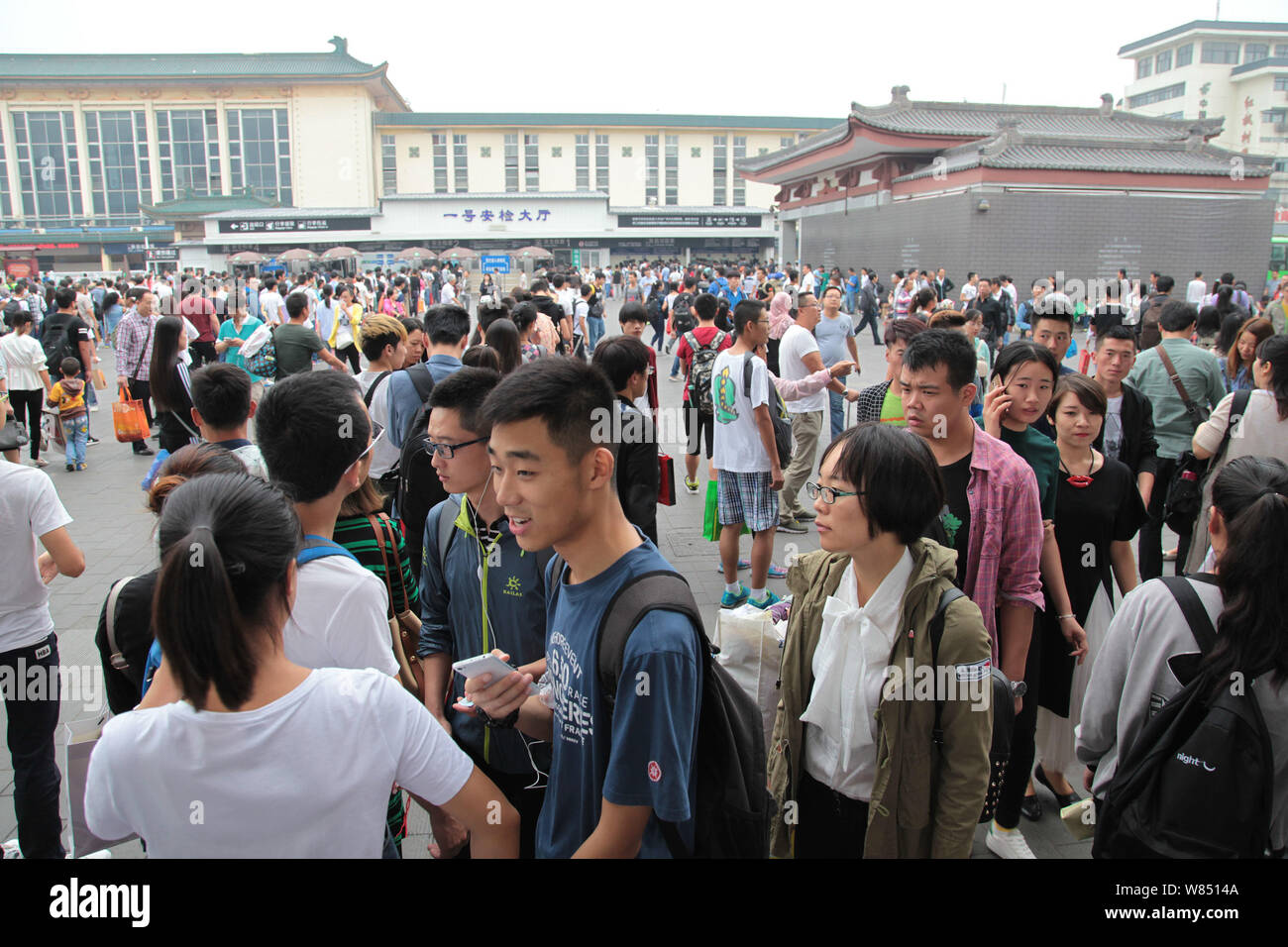 Chinese passengers queue up in front of the Xi'an Railway Station ...