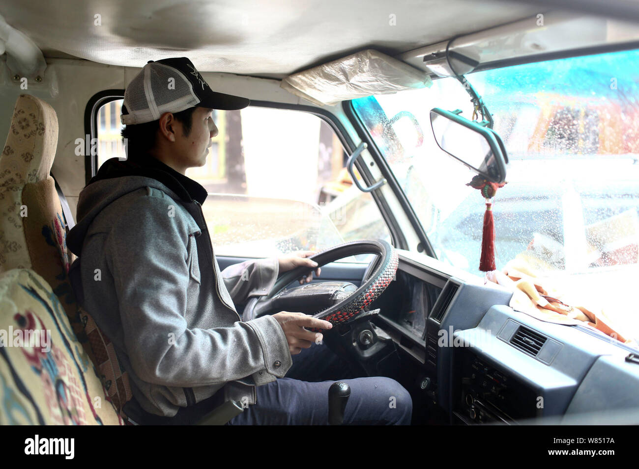 Chinese courier and station chief Yang Tao drives his pickup from the