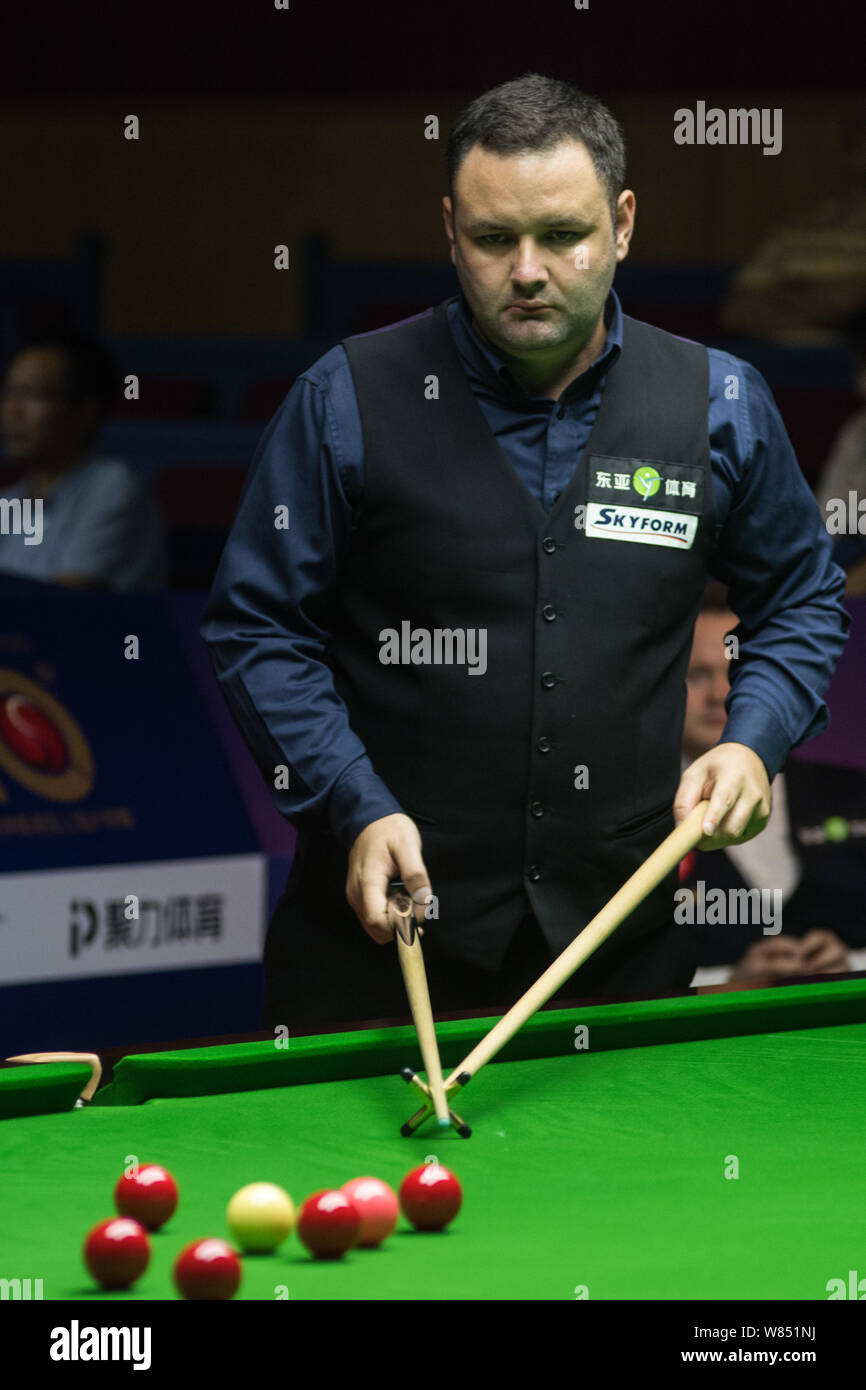 Stephen Maguire of Scotland plays a shot against Shaun Murphy of