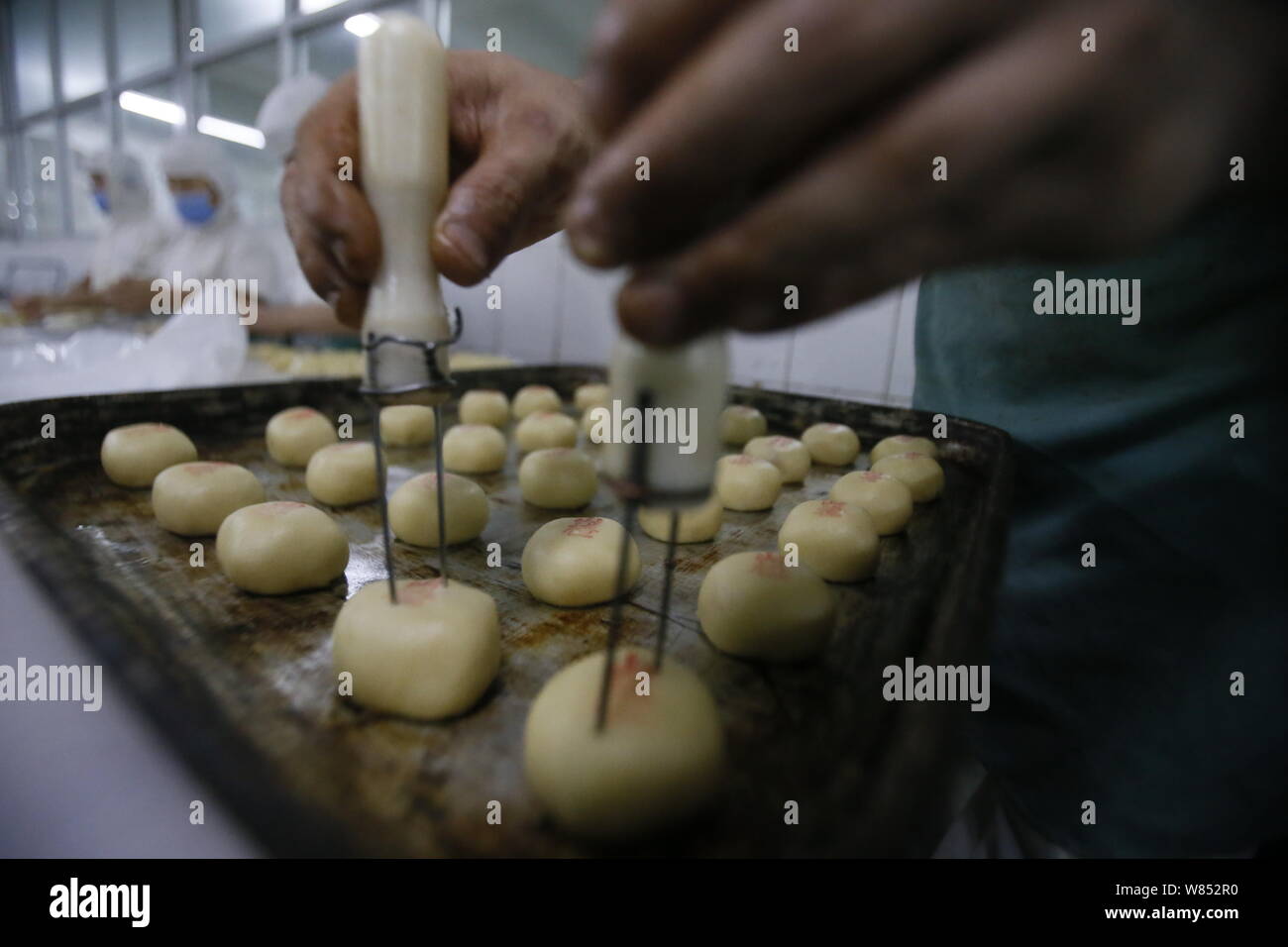 A Chinese worker makes mooncakes for the upcoming Mid-Autumn Festival ...