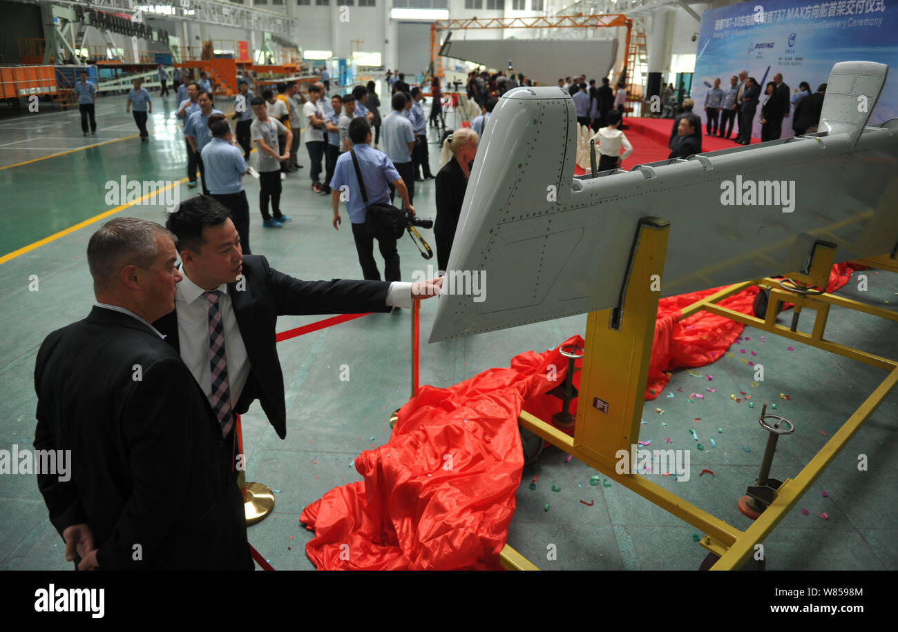 Guests look at the first rudder during the delivery ceremony of the ...