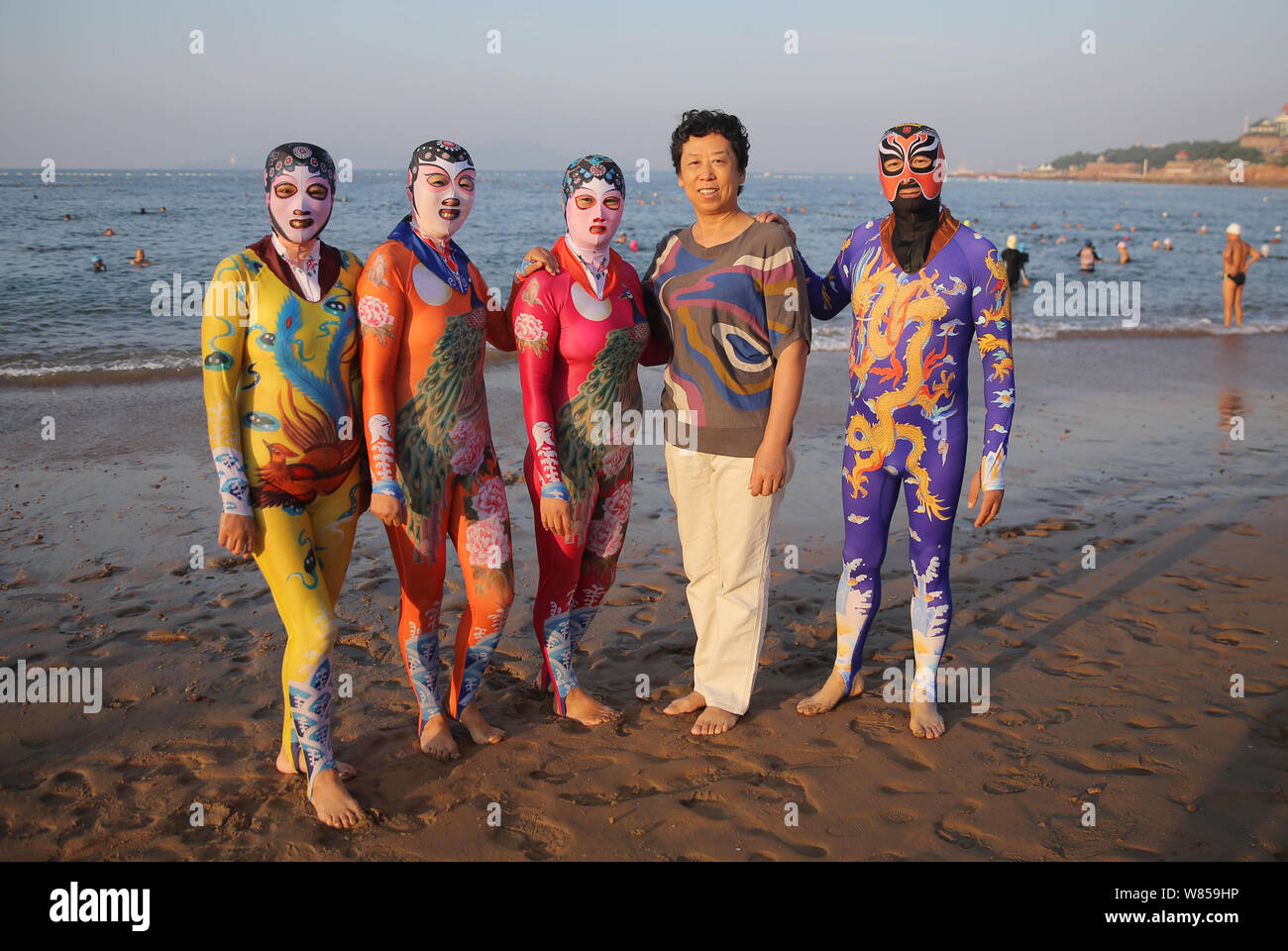 Chinese facekini designer Zhang Shifan, second right, poses with