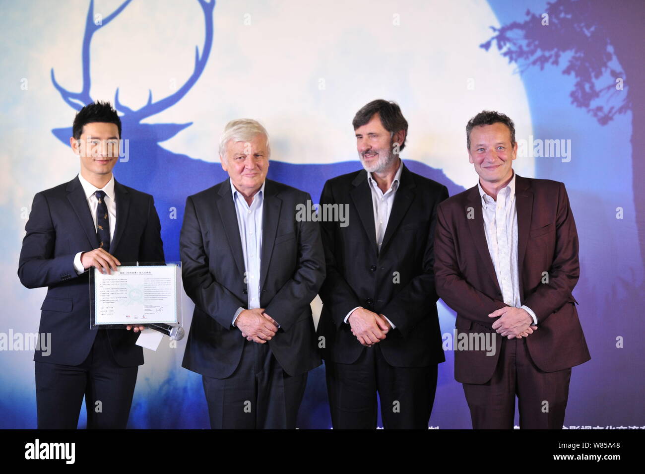 (From left) Chinese actor Huang Xiaoming, French directors Jacques Perrin and Jacques Cluzaud attend a premiere conference of the documentary movie 'T Stock Photo