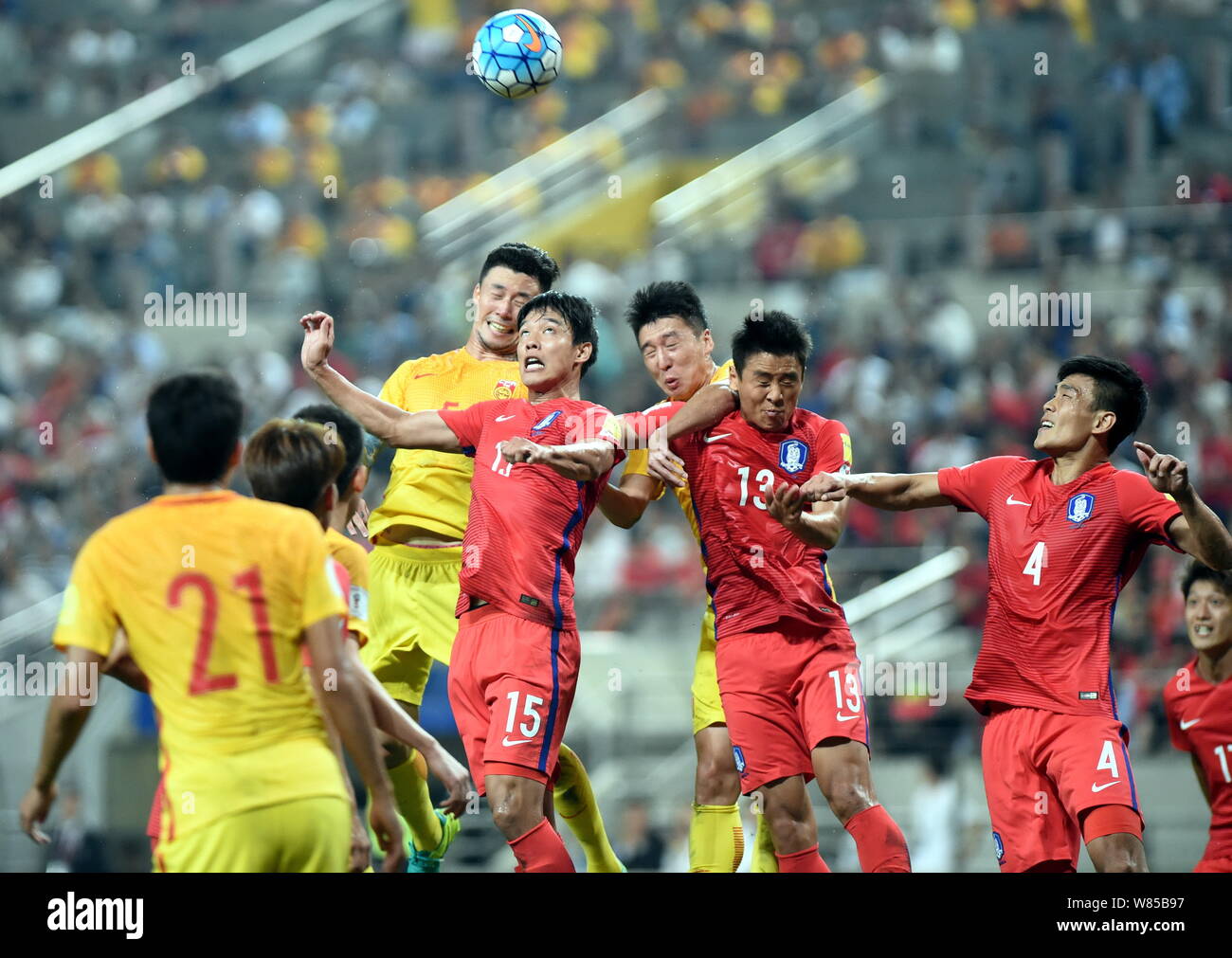 (From right) Kim Kee-hee, Koo Ja-cheol and Hong Jeong-ho of South Korea challenge footballers of China during their Group A soccer match of the FIFA W Stock Photo