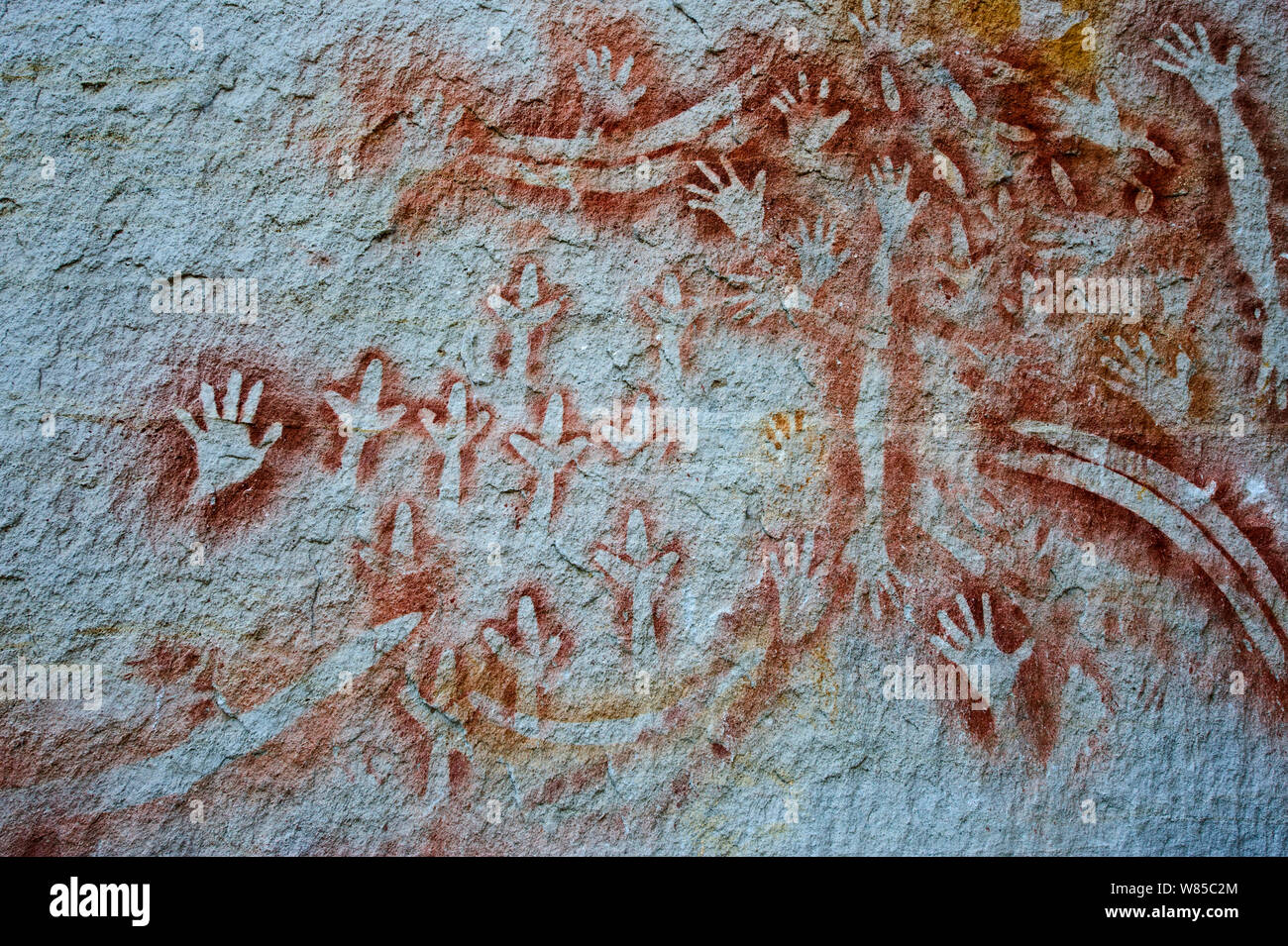 Aboriginal rock art at the 'Art Gallery' in Carnarvon Gorge, Queensland. Stencil art measured to be 2000 years old shows depictions of hands boomerangs Rock Wallaby bones and Emu feet. Stock Photo