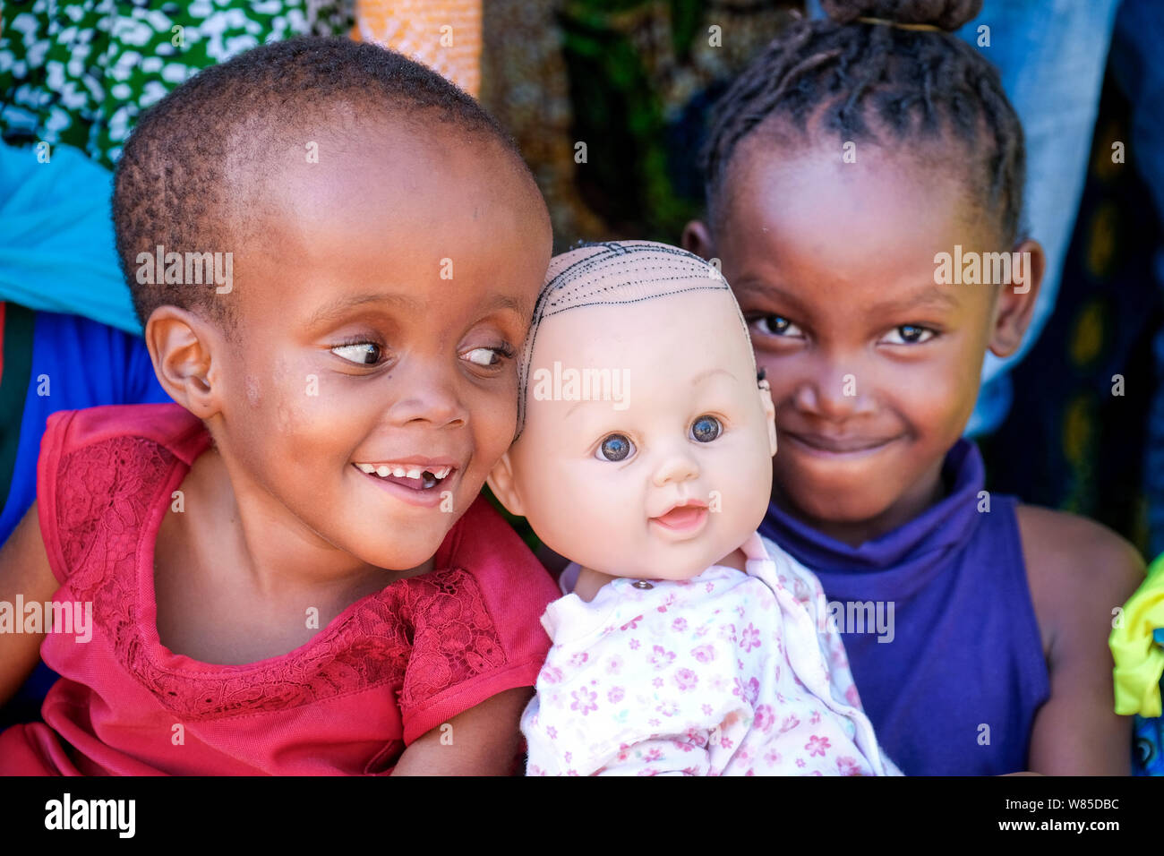 Two children with a doll in the 'House of Hope' for children with Hydrocephalus & Spina Bifida near Mwanza, Tanzania, Africa Stock Photo