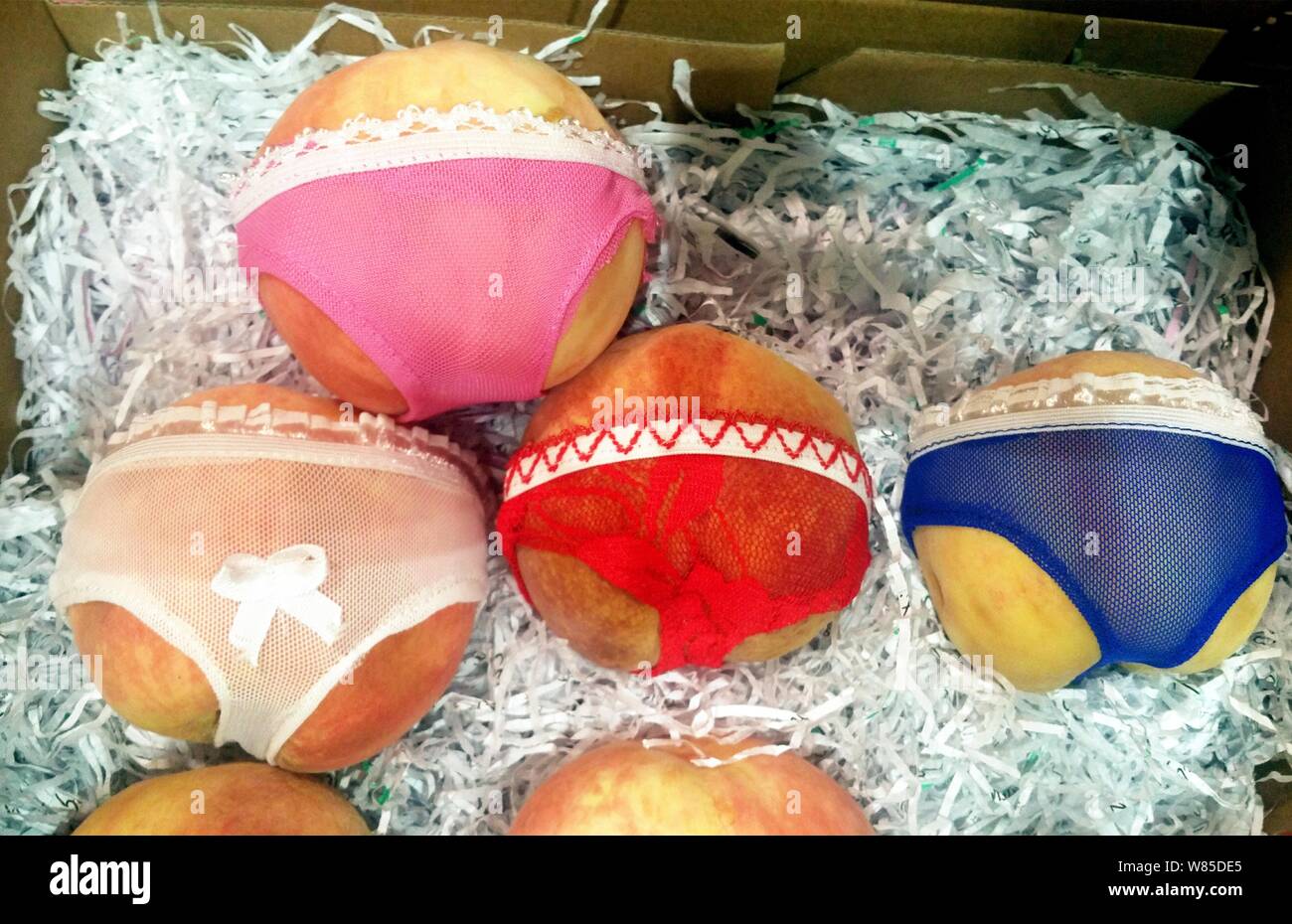 Panty-wearing peaches are for sale at a fruit shop in Qingdao city