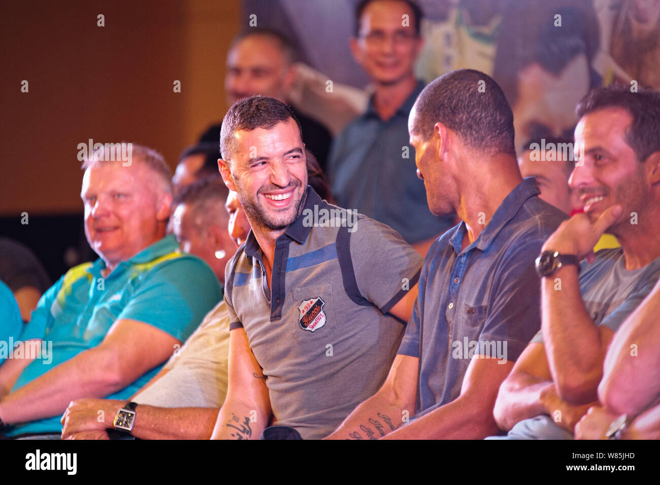 Portuguese soccer star Simao Sabrosa, second left, talks with Brazilian soccer star Rivaldo at a fan meeting event in Chengdu city, southwest China's Stock Photo