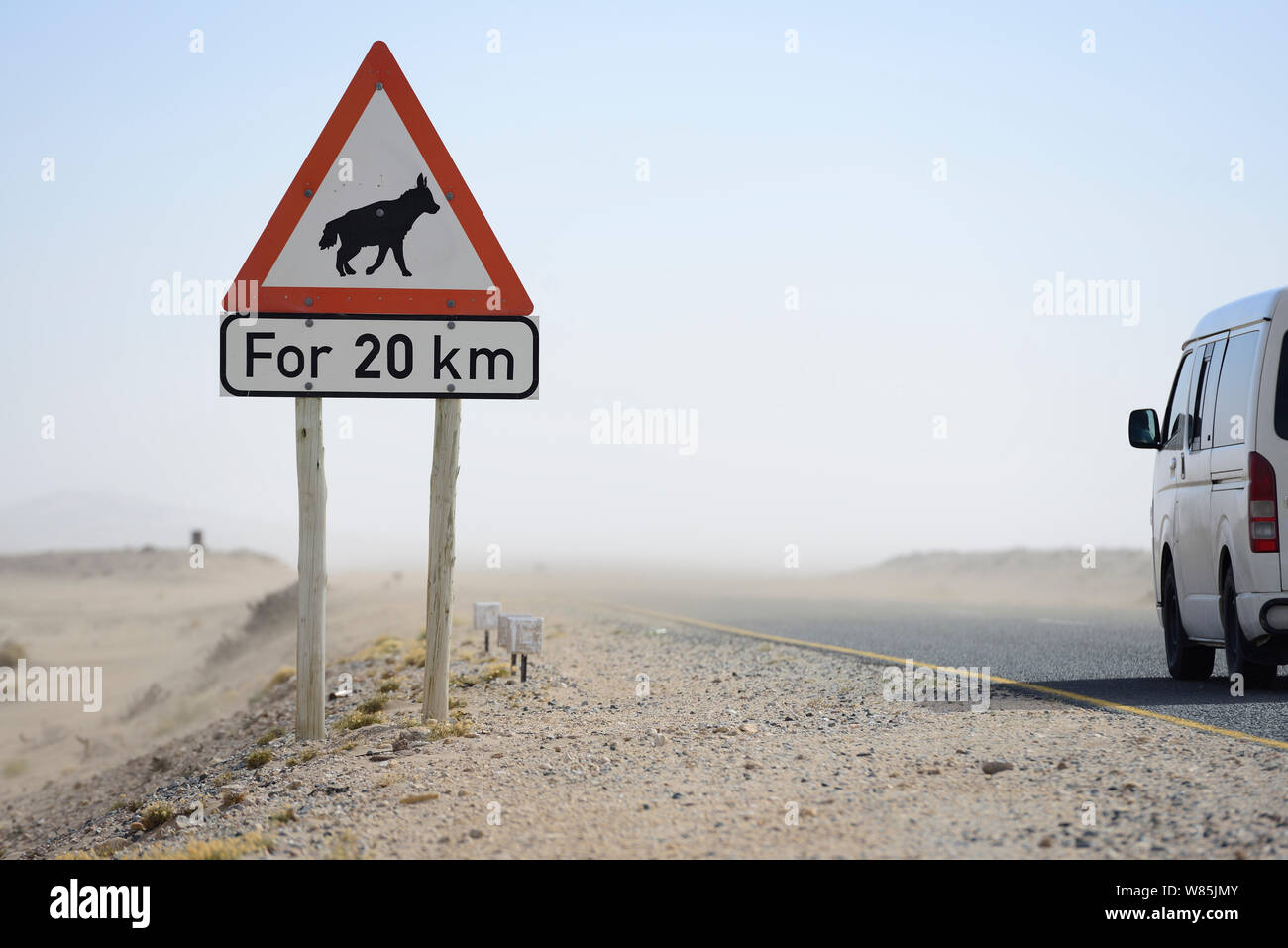 Traffic sign warning of brown hyaena (Hyaena brunnea) crossing, Luderitz, Namib desert, Namibia, November. Stock Photo