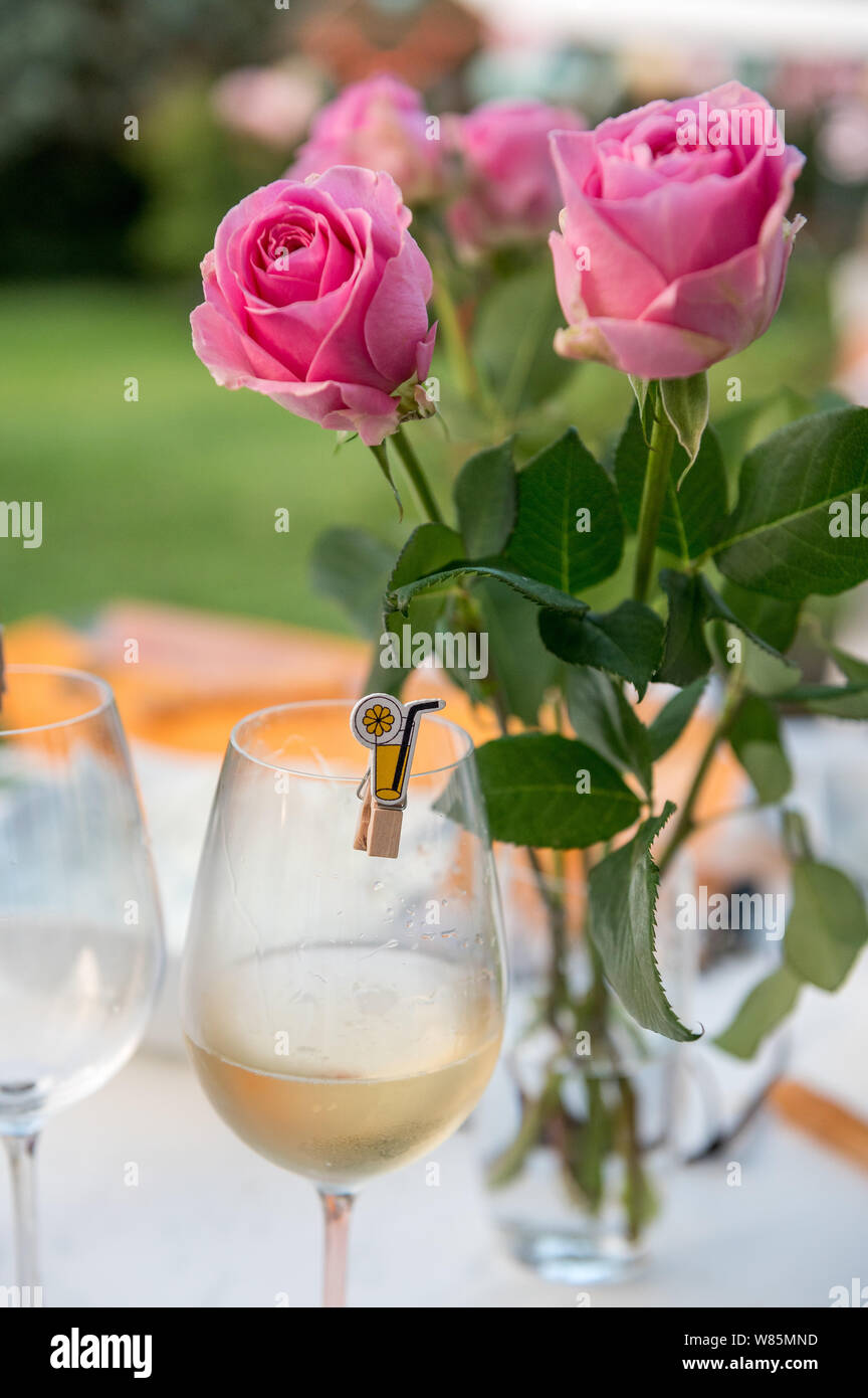 glass of white wine with roses Stock Photo