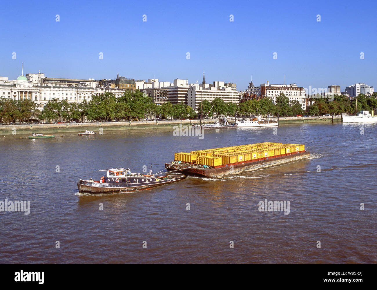Tugboat towing floating container barge on River Thames, South Bank, London Borough of Lambeth, Greater London, England, United Kingdom Stock Photo