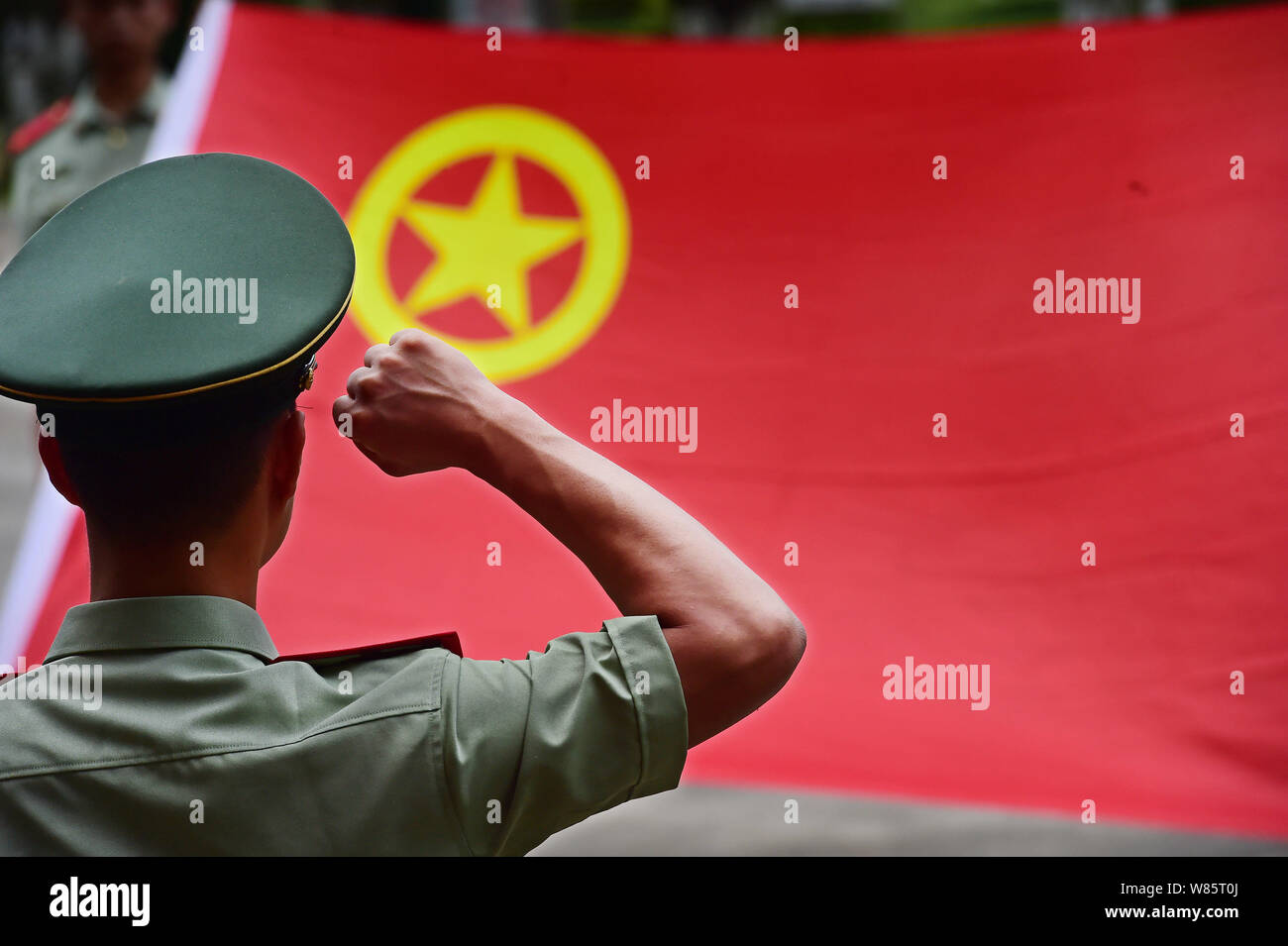 --FILE--A Chinese paramilitary policeman swears in before a flag of the Chinese Communist Youth League in Shenzhen city, south China's Guangdong provi Stock Photo