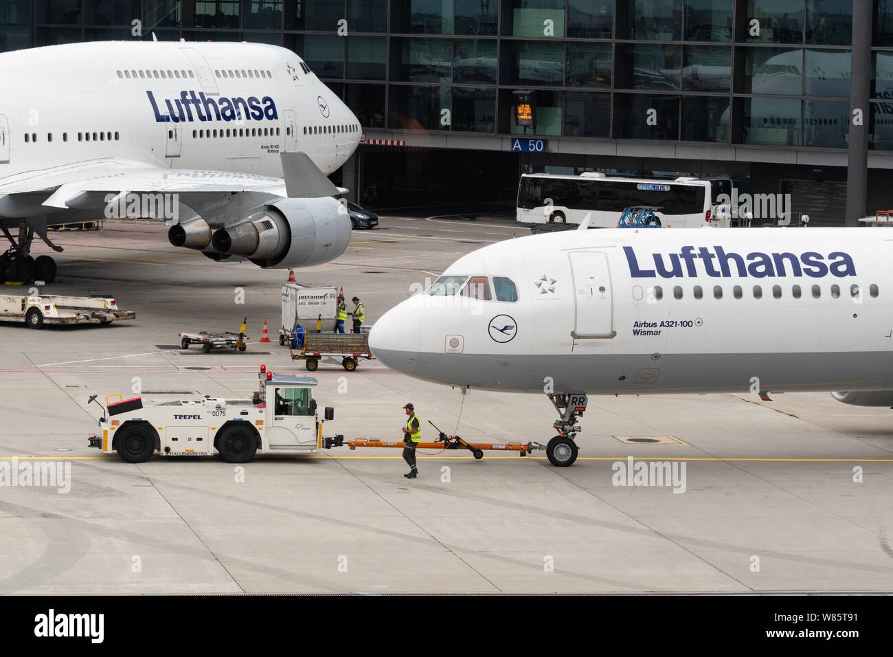 Lufthansa planes and Frapart ground crew, Frankfurt airport, Germany Stock Photo