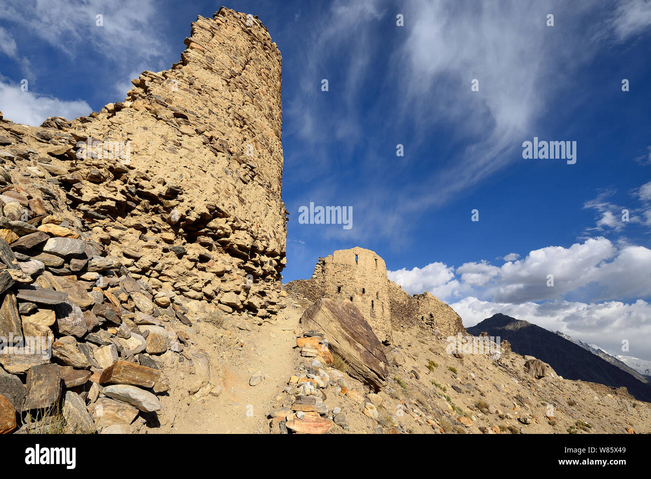 View on the Wakhan Valley in the Pamir mountain, The ruins of the Yamchun Fort and the white Hindu Kush range in Afghanistan, Tajikistan, Central Asia Stock Photo
