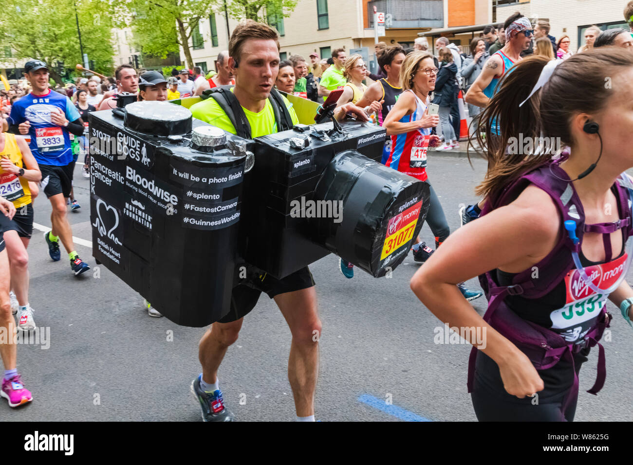 England, London, London Marathon 2019, Runner Carrying Model Camera Stock Photo