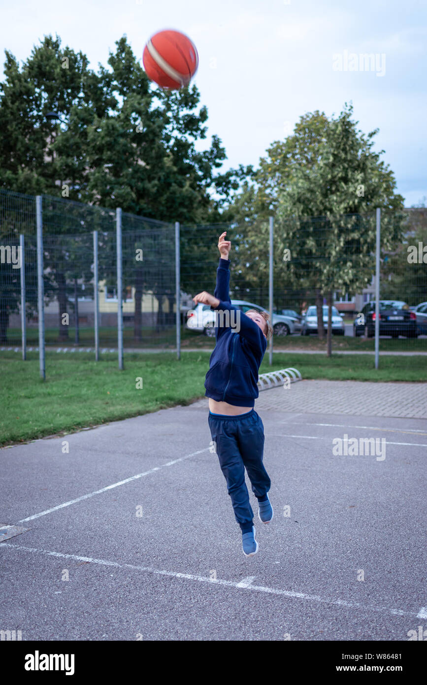 Photo Of Boy Throwing Basketball in play Square Stock Photo Alamy