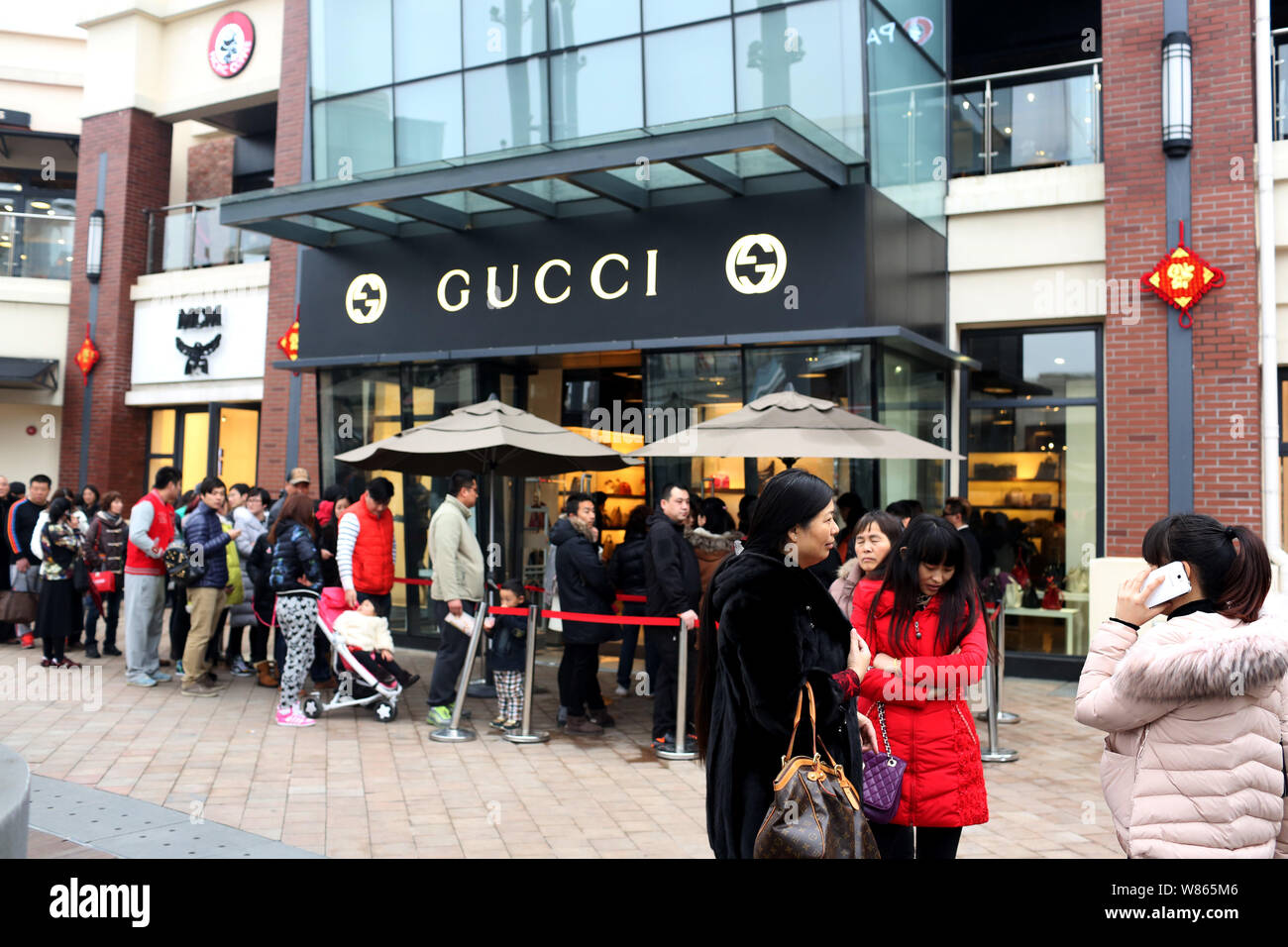 FILE--Chinese customers queue up outside a fashion boutique of