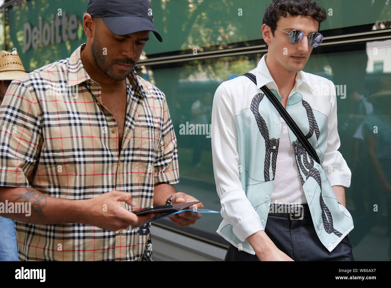 MILAN, ITALY - JUNE 15, 2019: Men with Burberry shirt and white and blue  shirt before Emporio Armani fashion show, Milan Fashion Week street style  Stock Photo - Alamy