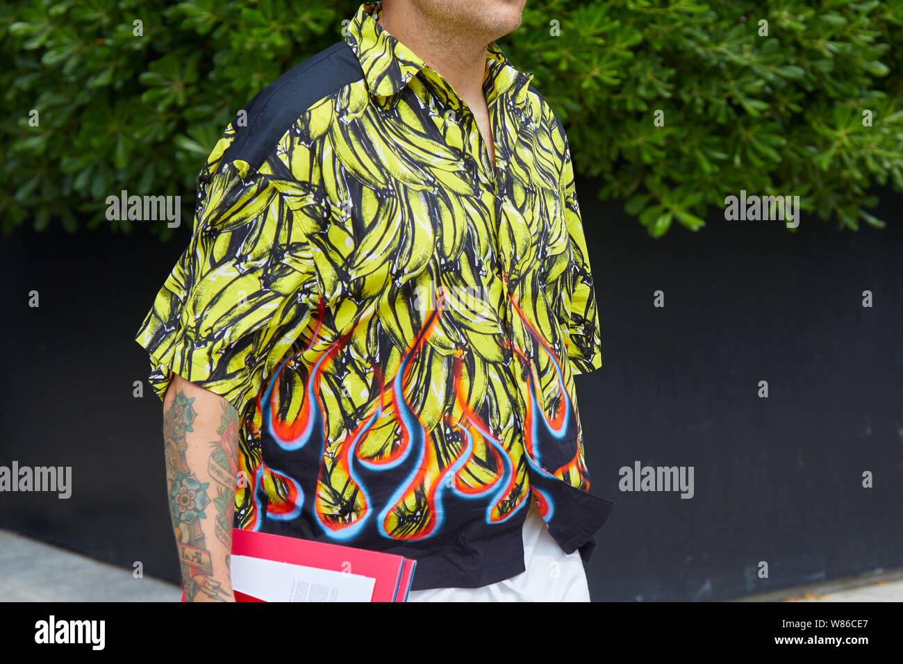 MILAN, ITALY - JUNE 15, 2019: Man with shirt with banana design and flames  before Neil Barrett fashion show, Milan Fashion Week street style Stock  Photo - Alamy