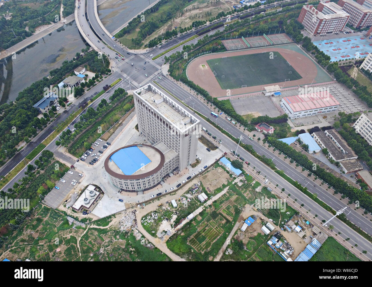 Aerial view of a building resembling a flush toilet in the Longzihu