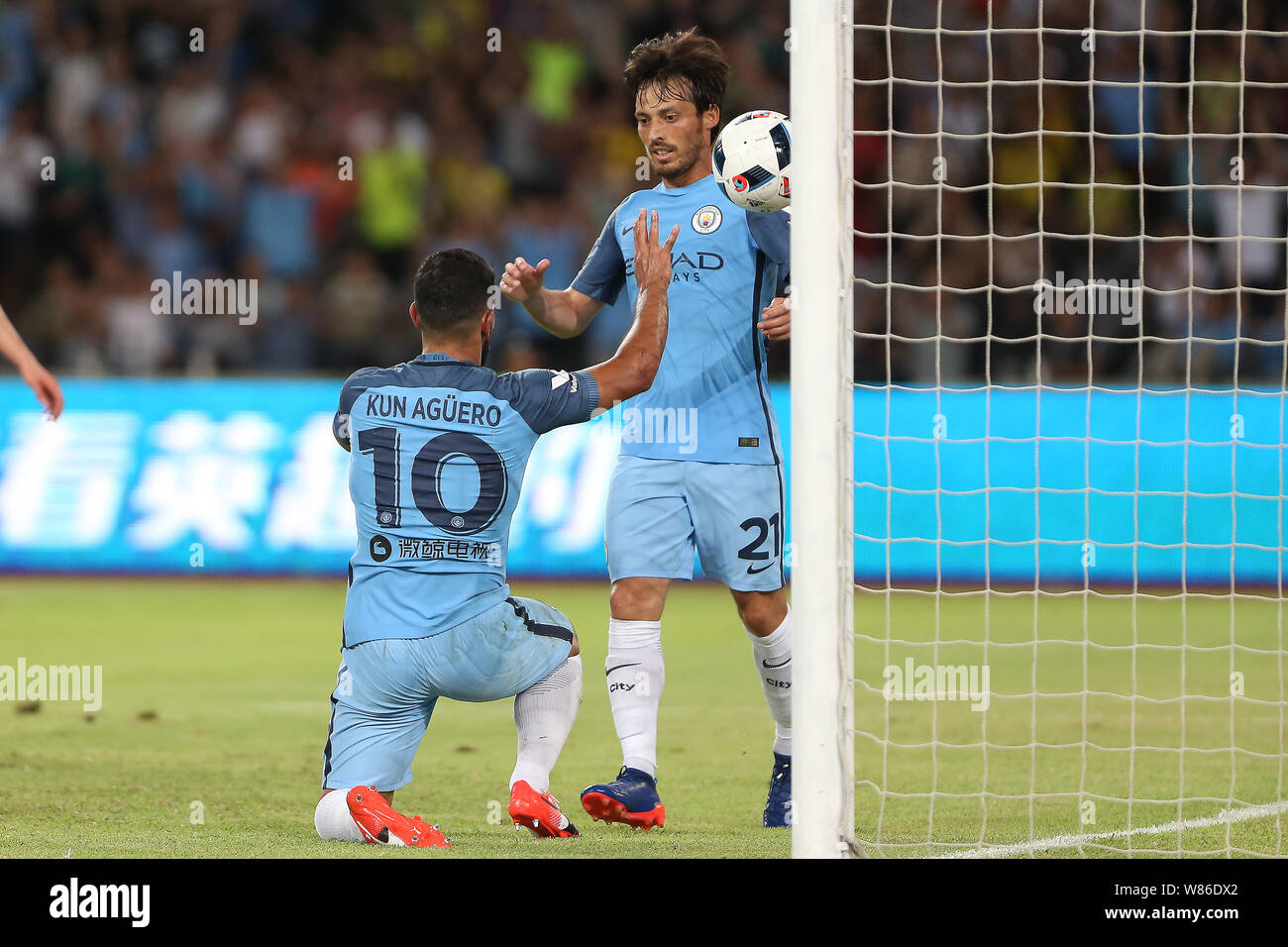 Sergio Aguero of Manchester City, front, celebrates with David Silva after scoring a goal against Borussia Dortmund during the Shenzhen match of the 2 Stock Photo