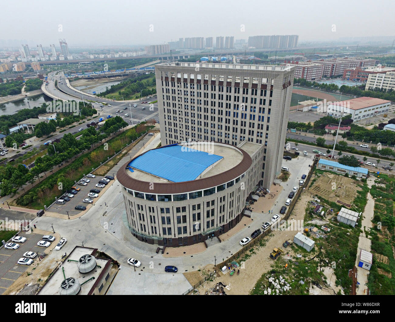 Aerial view of a building resembling a flush toilet in the Longzihu