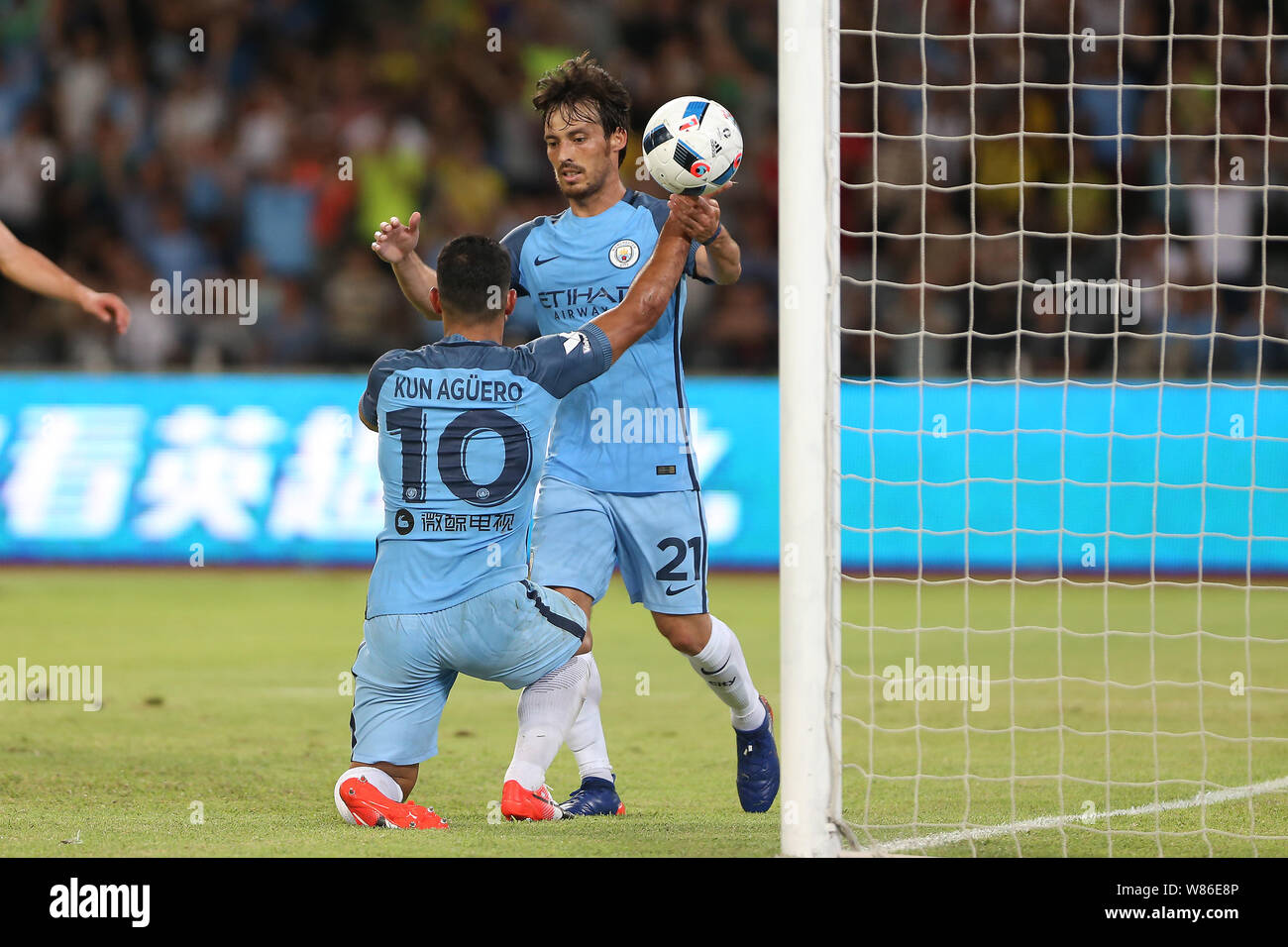 Sergio Aguero of Manchester City, front, celebrates with David Silva after scoring a goal against Borussia Dortmund during the Shenzhen match of the 2 Stock Photo