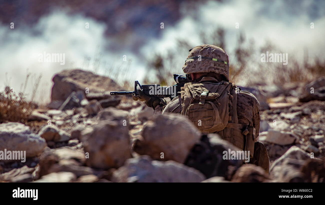 A U.S. Marine with 1st Battalion, 25th Marine Regiment, 4th Marine Division, engages simulated hostiles at Range 400 during Integrated Training Exercise 5-19 at Marine Corps Air Ground Combat Center Twentynine Palms, Calif., Aug. 5, 2019. Reserve Marines with 1/25 participate in ITX to prepare for their upcoming deployment to the Pacific Region. (U.S. Marine Corps photo by Lance Cpl. Jose Gonzalez) Stock Photo