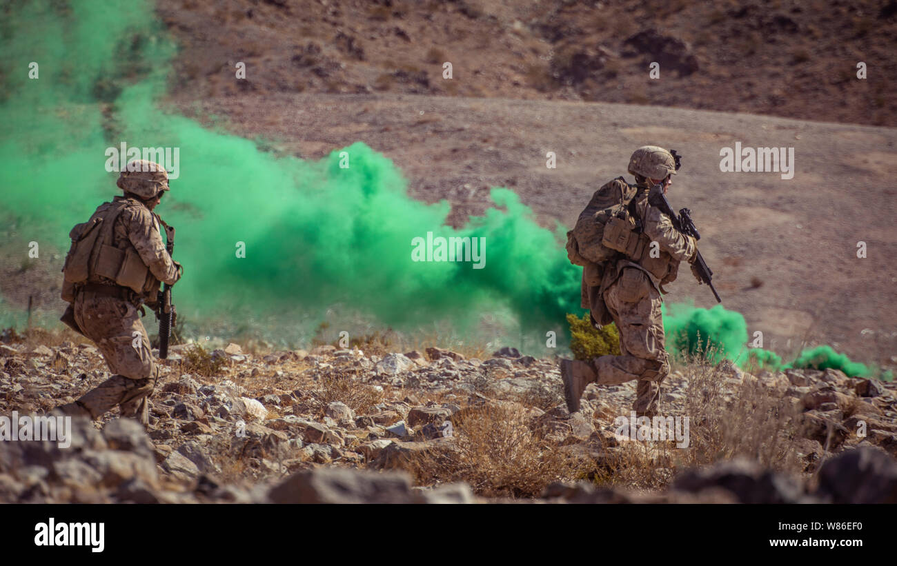 U.S. Marines with 1st Battalion, 25th Marine Regiment, 4th Marine Division, rush towards their next objective at Range 400 during Integrated Training Exercise 5-19 at Marine Corps Air Ground Combat Center Twentynine Palms, Calif., Aug. 5, 2019. Reserve Marines with 1/25 participate in ITX to prepare for their upcoming deployment to the Pacific Region. (U.S. Marine Corps photo by Lance Cpl. Jose Gonzalez) Stock Photo