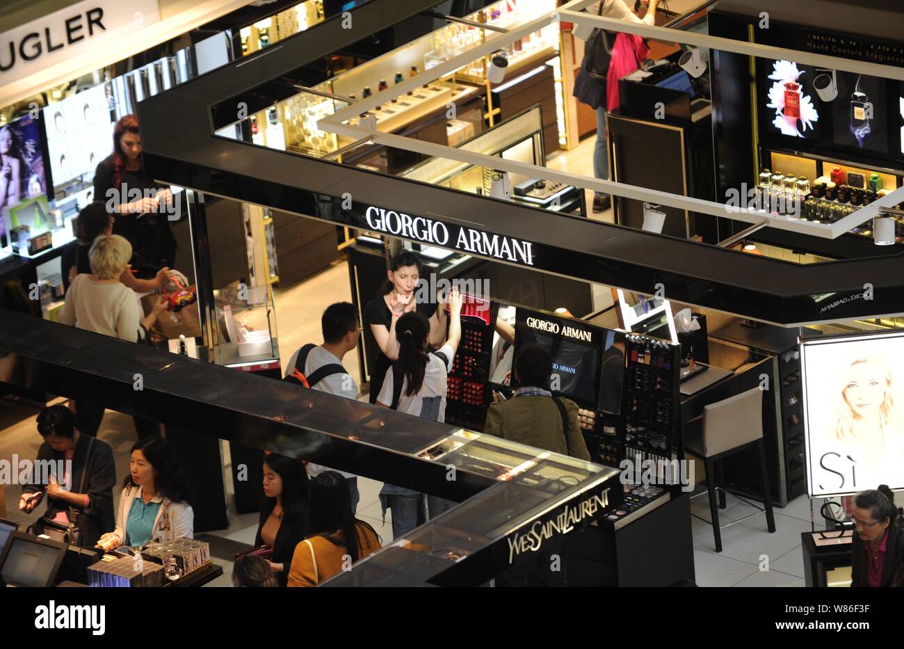 Chinese customers shop for cosmetics and skincare products at counters of  Yves Saint Laurent (YSL) and Giorgio Armani at the Galeries Lafayette  depart Stock Photo - Alamy