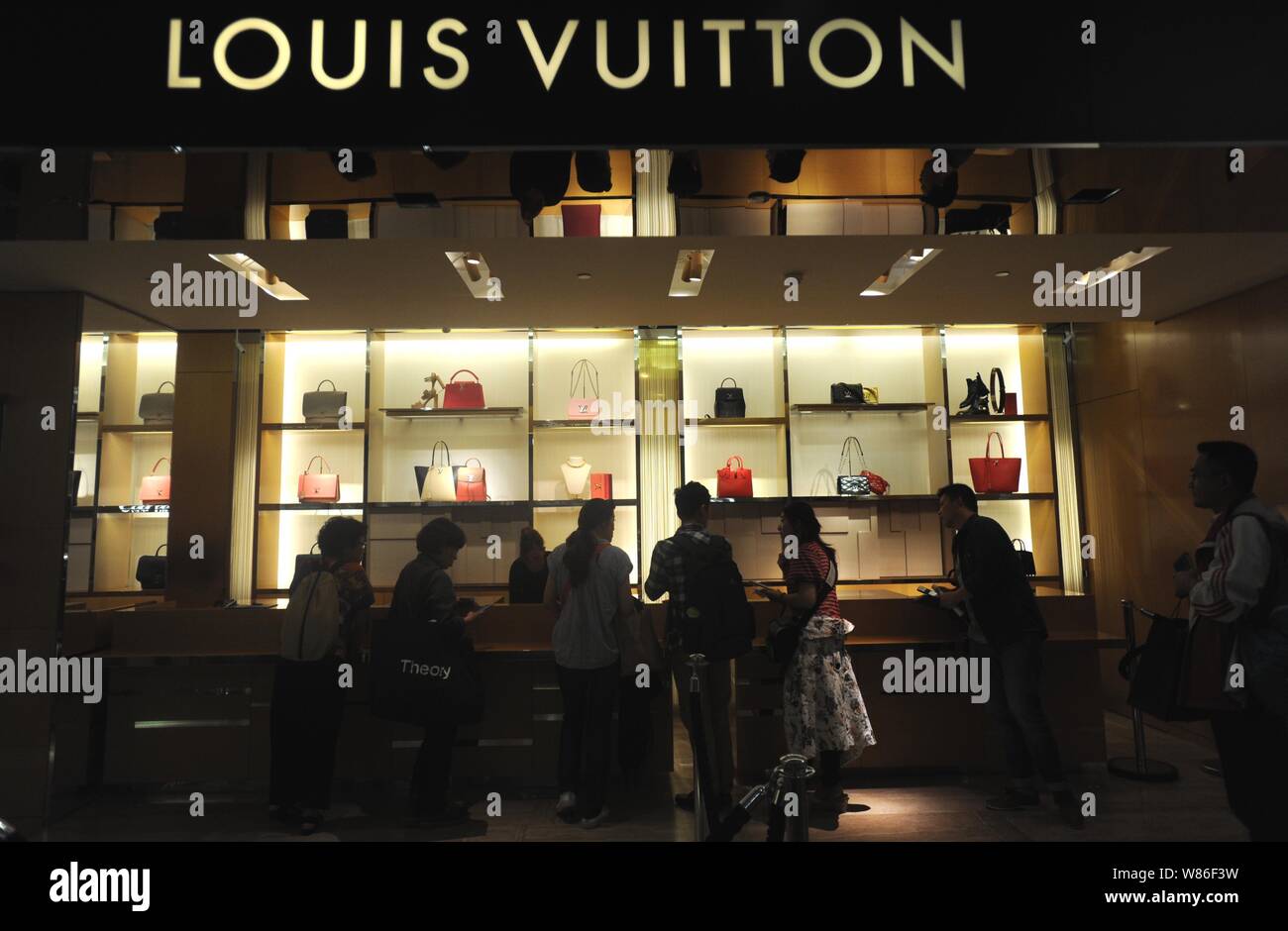 Chinese customers shop at a boutique of Louis Vuitton (LV) at the Galeries  Lafayette department store during the 2016 "Les Soldes" Summer Sales in Par  Stock Photo - Alamy