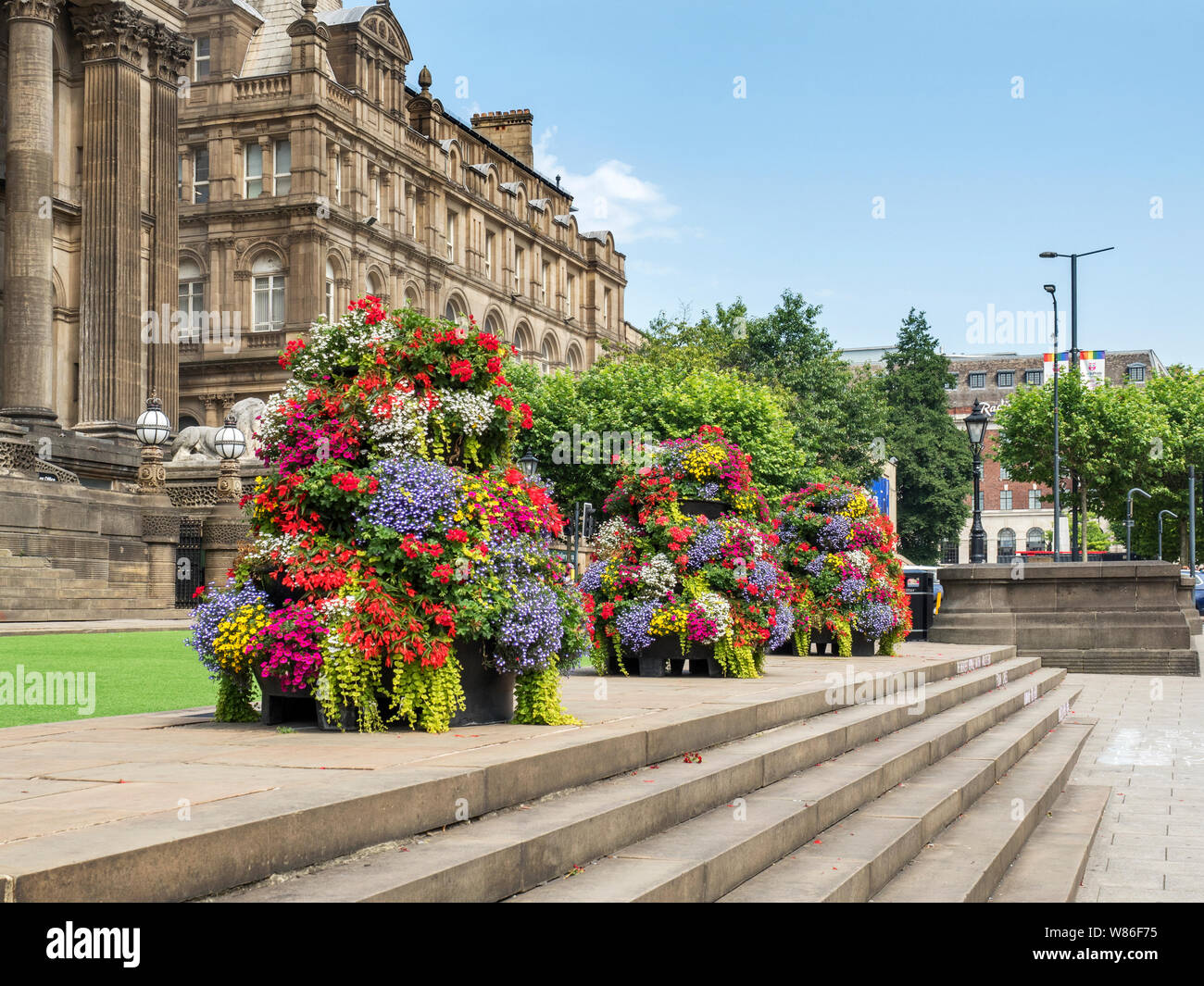 Colourful flower display on the steps at Leeds Town Hall on The Headrow in Leeds West Yorkshire England Stock Photo