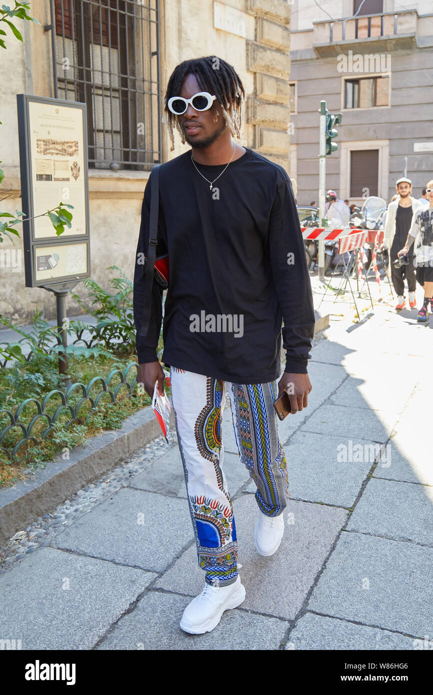 MILAN, ITALY - JUNE 16, 2019: Man with black shirt and white sneakers  walking before Les Hommes fashion show, Milan Fashion Week street style  Stock Photo - Alamy