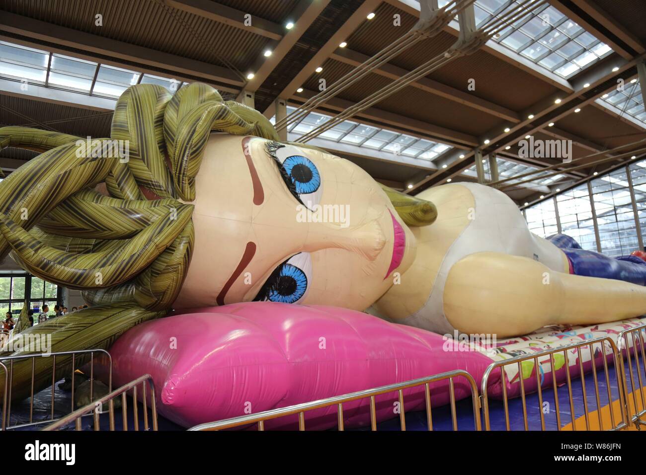 A giant inflatable doll is on display during the 2016 Shenzhen Cartoon and Animation Festival in Shenzhen city, south China's Guangdong province, 21 J Stock Photo