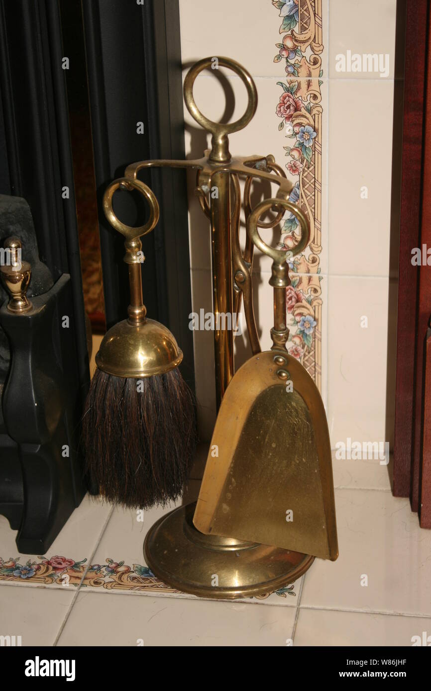 vintage brass fireside companion set on the hearth Stock Photo
