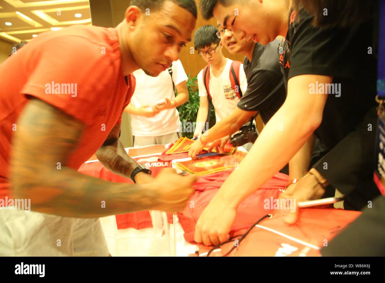 Memphis Depay of Manchester United signs autographs for Chinese fans at a fan meeting in Beijing, China, 24 July 2016. Stock Photo