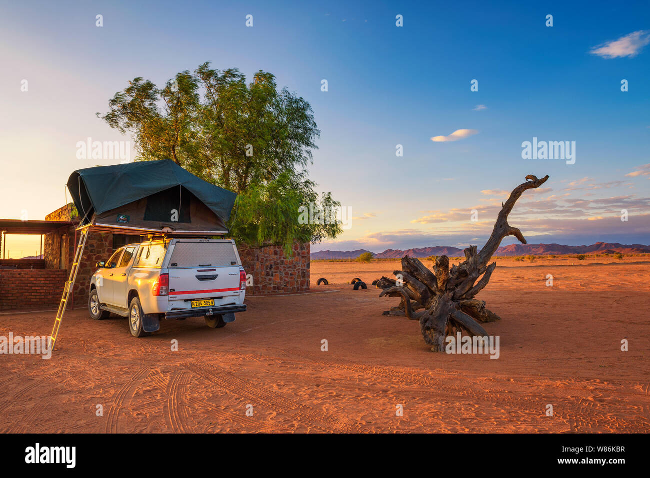 Tent located on the roof of a pickup 4x4 car in a desert camp, Namibia Stock Photo