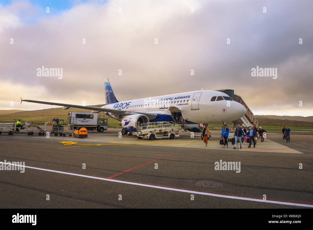 Passengers disembark from airplane at the Faroe Islands airport Stock Photo