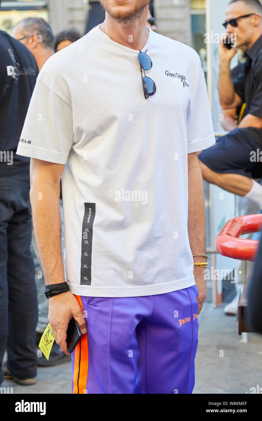 MILAN, ITALY - JUNE 16, 2019: Man with purple and orange Palm Angels  trousers and shirt before Palm Angels fashion show, Milan Fashion Week  street sty Stock Photo - Alamy