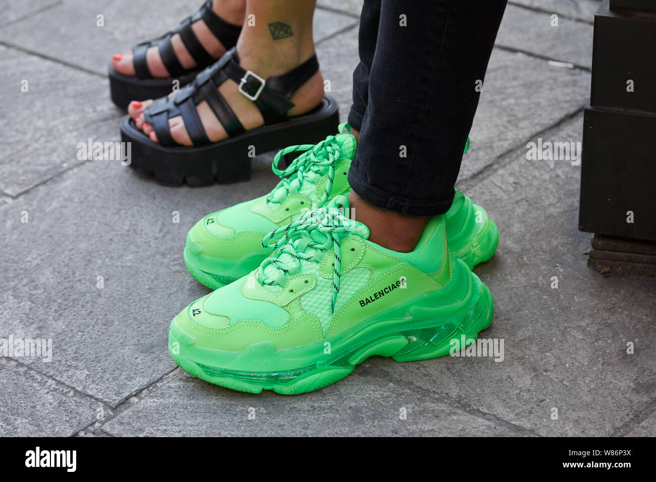MILAN, ITALY - JUNE 16, 2019: Man with green metallic trousers and Moschino  sneakers before Palm Angels fashion show, Milan Fashion Week street style  Stock Photo - Alamy
