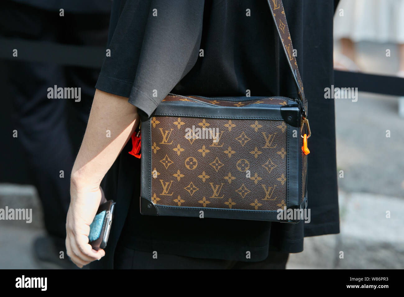 MILAN, ITALY - SEPTEMBER 18, 2019: Woman with Louis Vuitton black patent  leather bag before Prada fashion show, Milan Fashion Week street style  Stock Photo - Alamy
