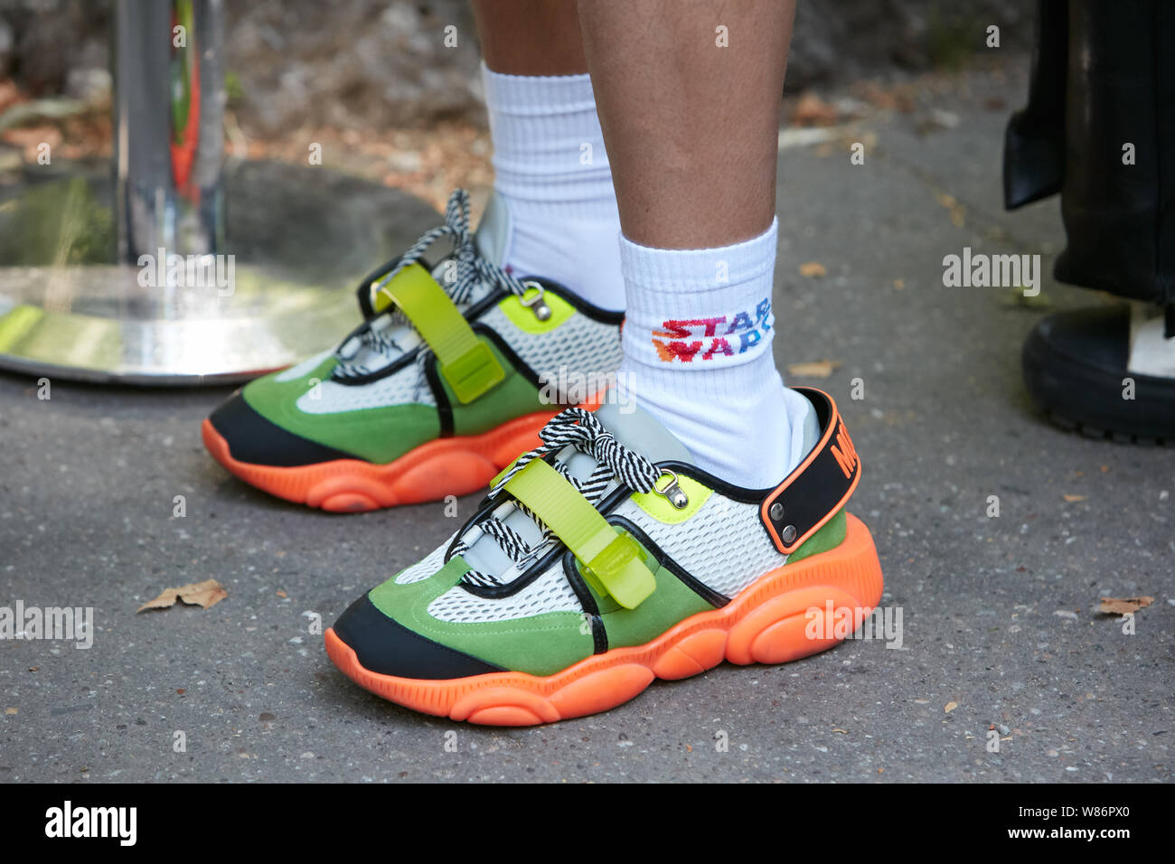 MILAN, ITALY - JUNE 17, 2019: Man with Moschino sneakers in orange and  green colors before Fendi fashion show, Milan Fashion Week street style  Stock Photo - Alamy