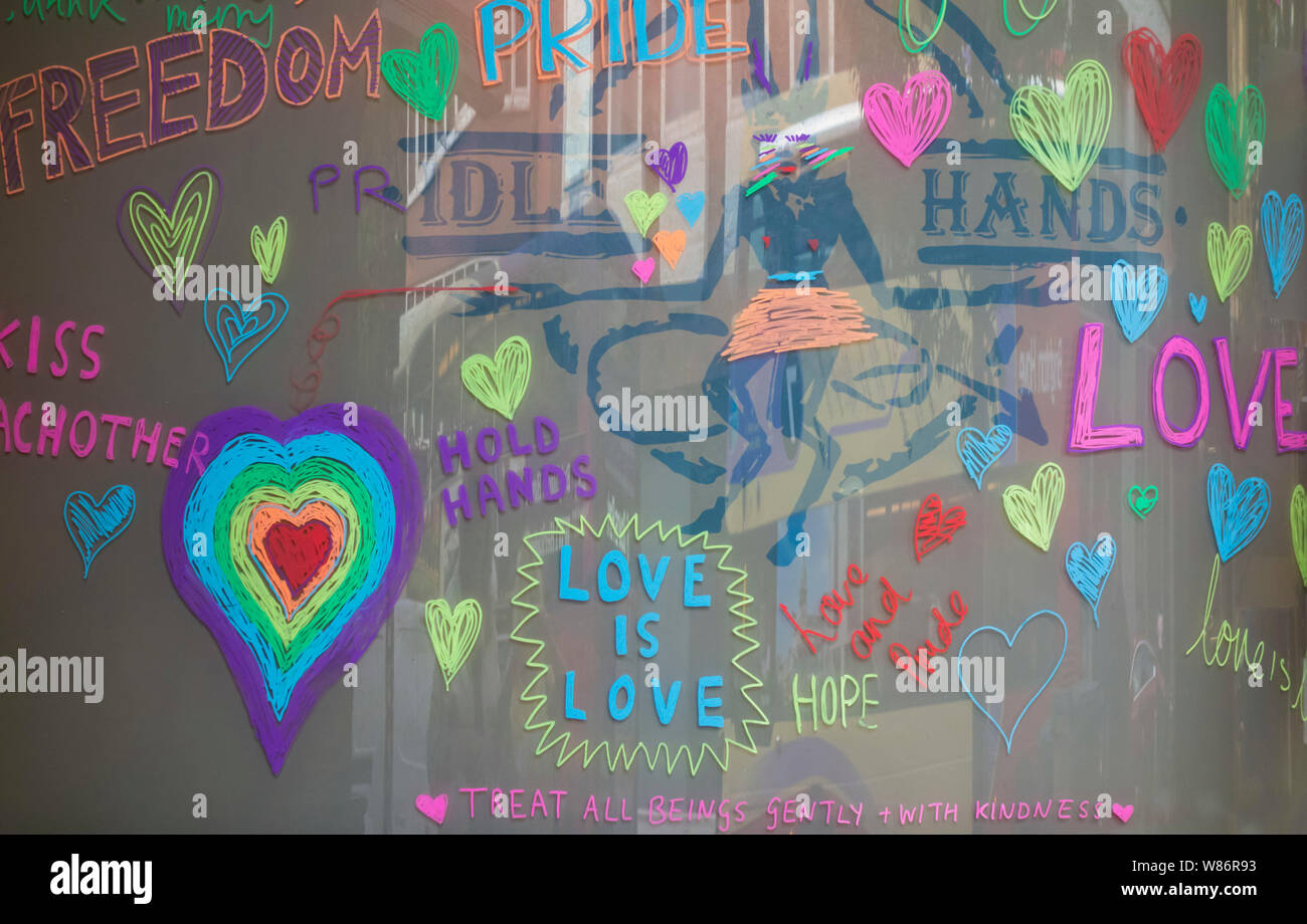 Colourful graffiti writing and hearts on window in support of LGBT pride Brighton East Sussex Stock Photo