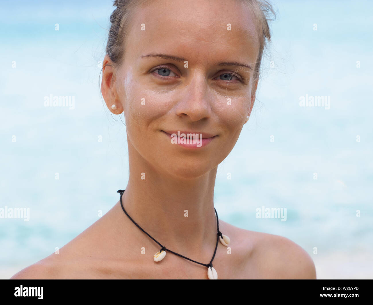 Portrait Of A Beautiful Slim Girl Wearing A Bikini Puts On Her Face