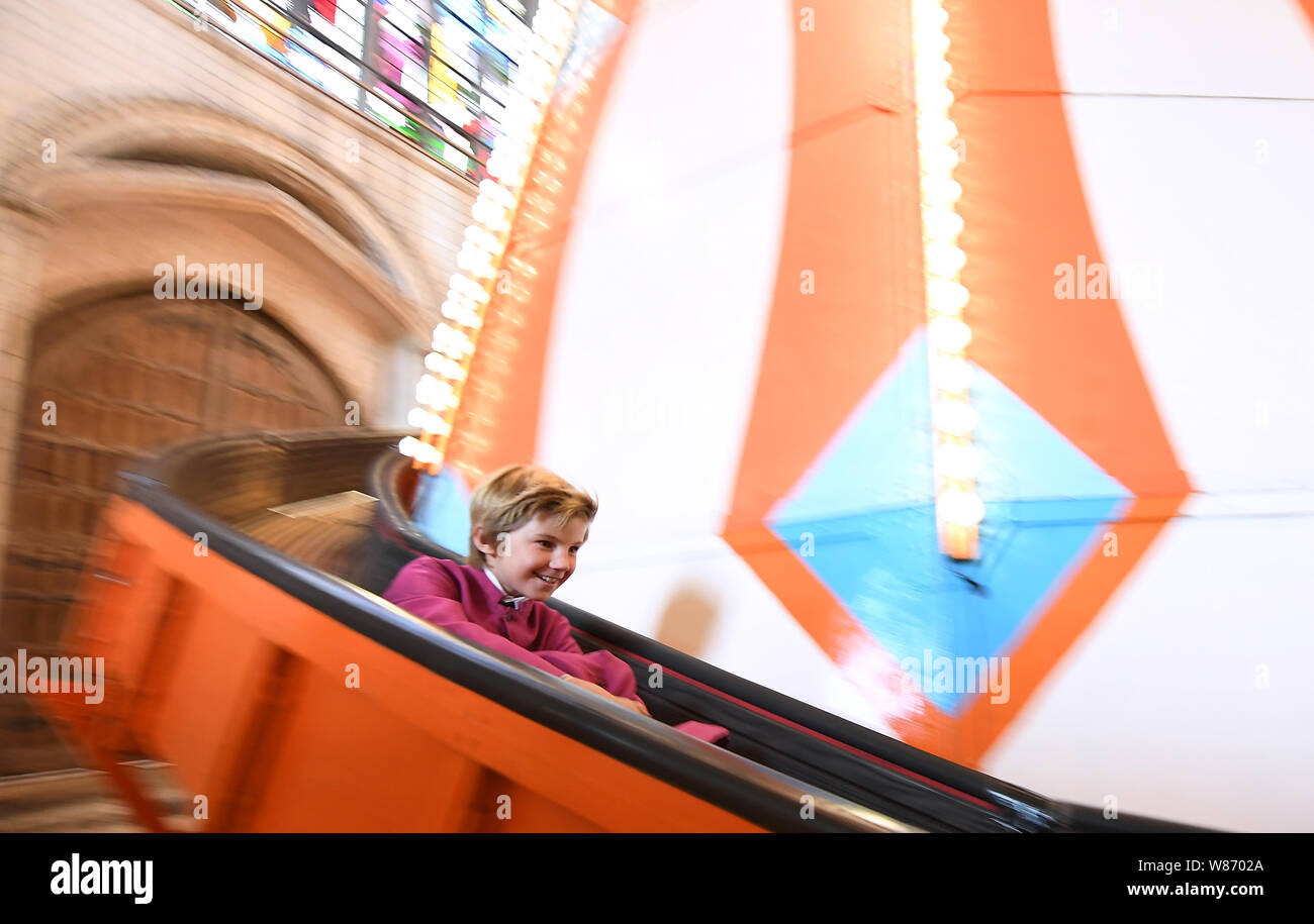 A chorister from Norwich Cathedral choir goes down a 40ft helter skelter installed inside Norwich Cathedral as part of the Seeing It Differently project which aims to give people the chance to experience the Cathedral in an entirely new way and open up conversations about faith. Stock Photo